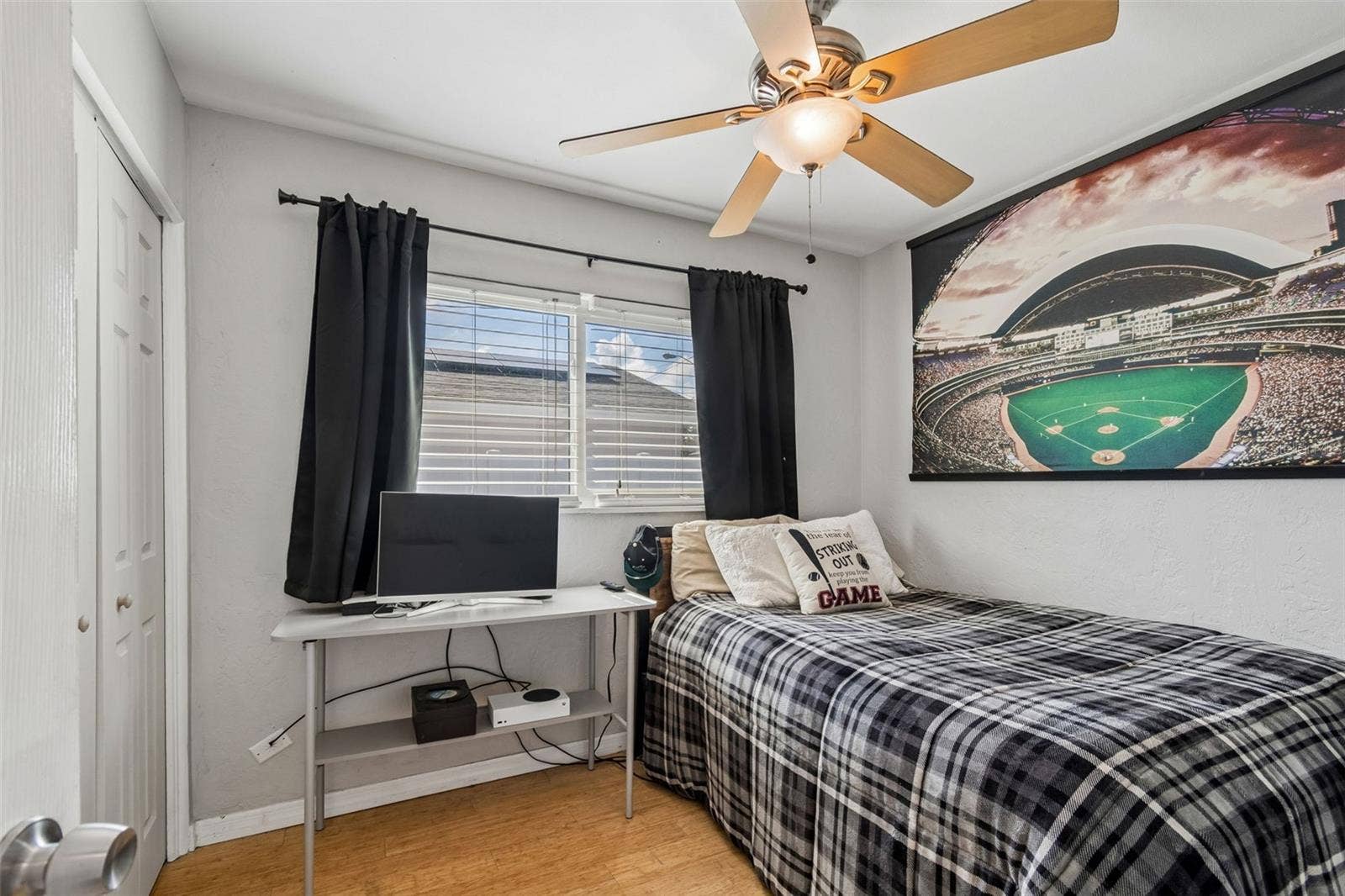Fourth bedroom with natural light and closet space.