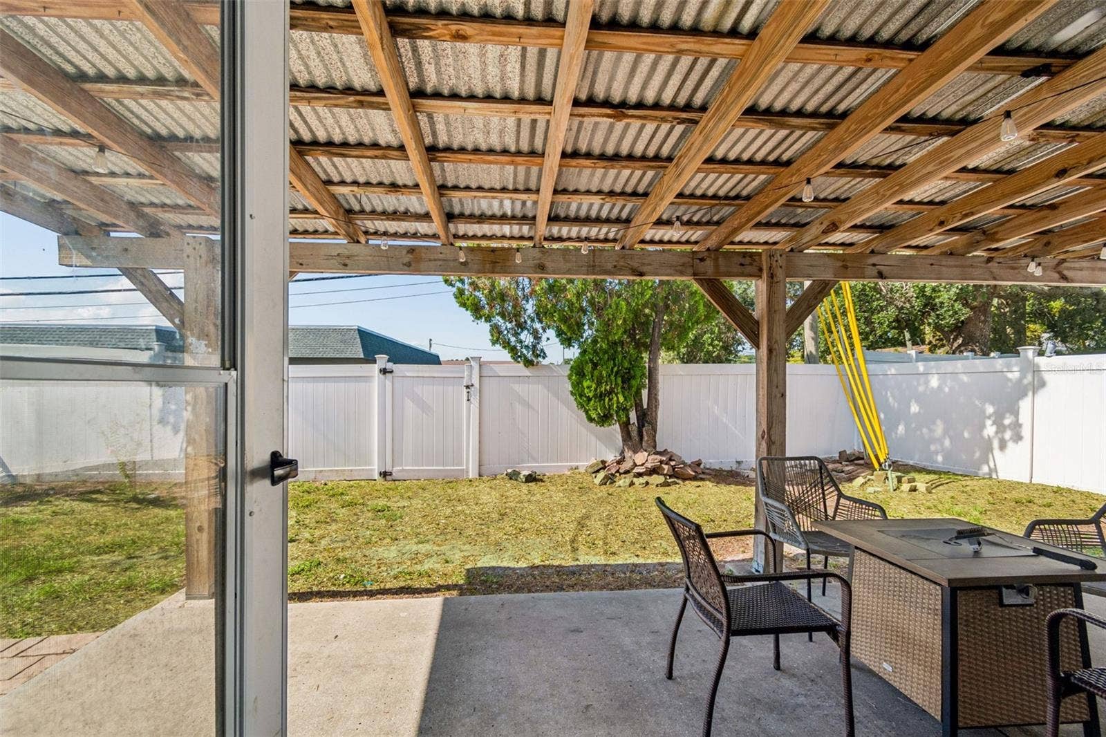 Covered outdoor living opens to a large, fully fenced backyard with room for pets, play and entertaining.