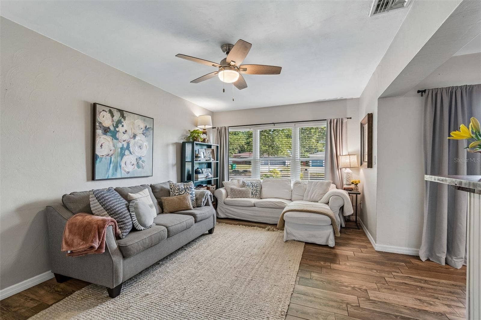 Bright and comfortable living space with plenty of natural light from the newer impact rated windows.