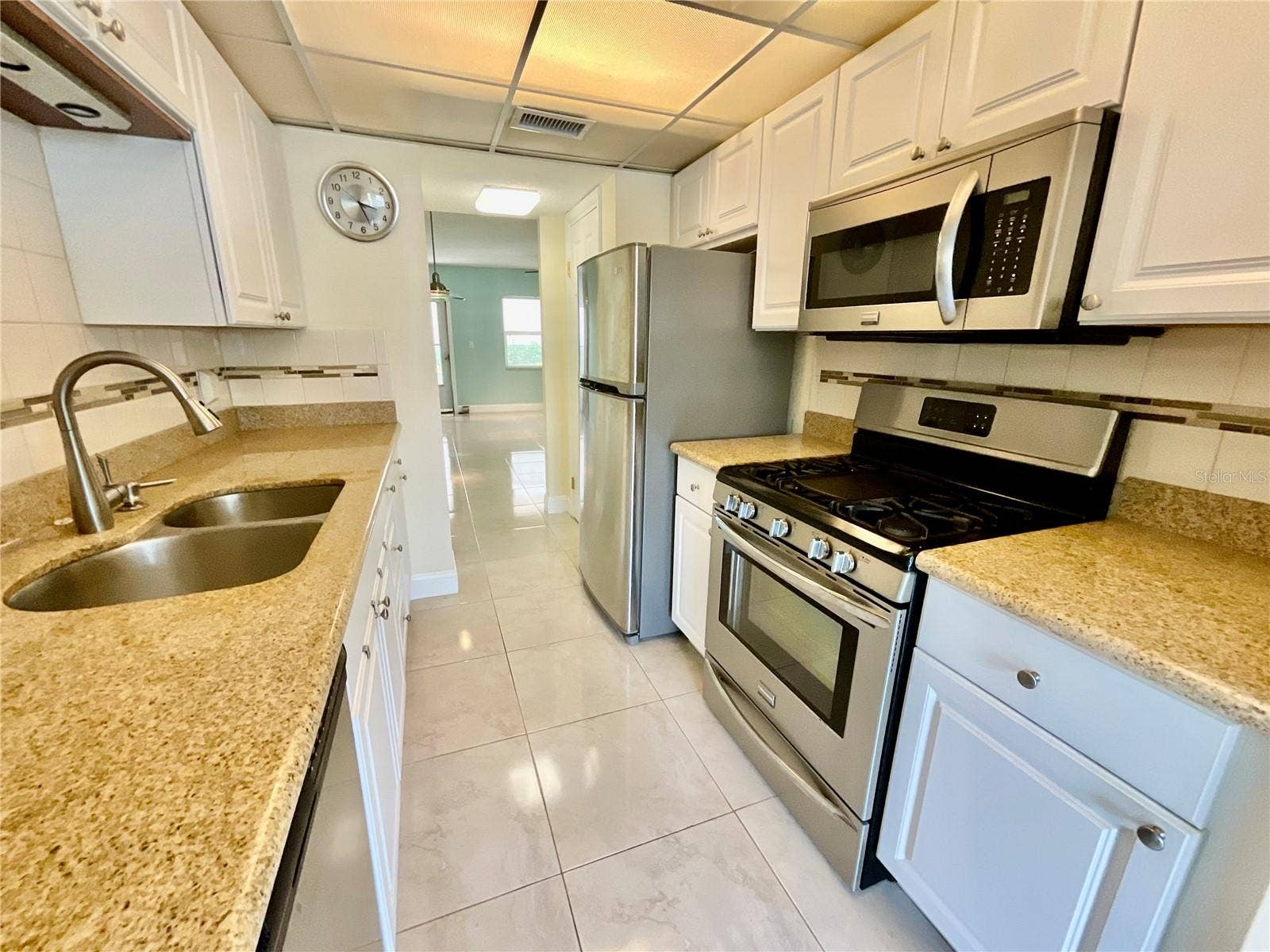 10034 64TH AVENUE N, #11, St Petersburg, FL 33708 Galley Kitchen with all electric appliances, ample cabinets/space and a separate, doored pantry