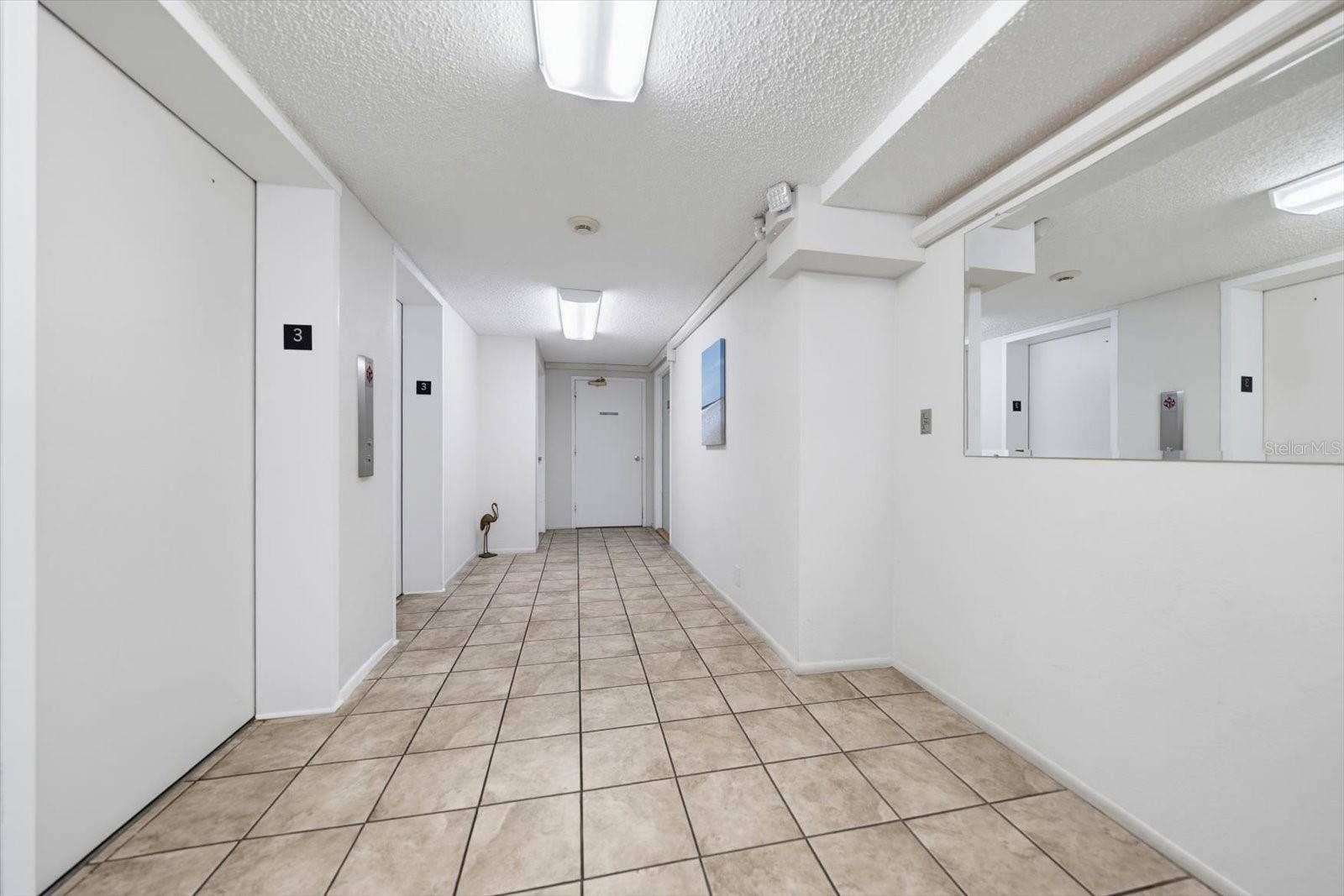 255 DOLPHIN POINT, #307, Clearwater Beach, FL 33767 Hallway to Elevators & Laundry Room