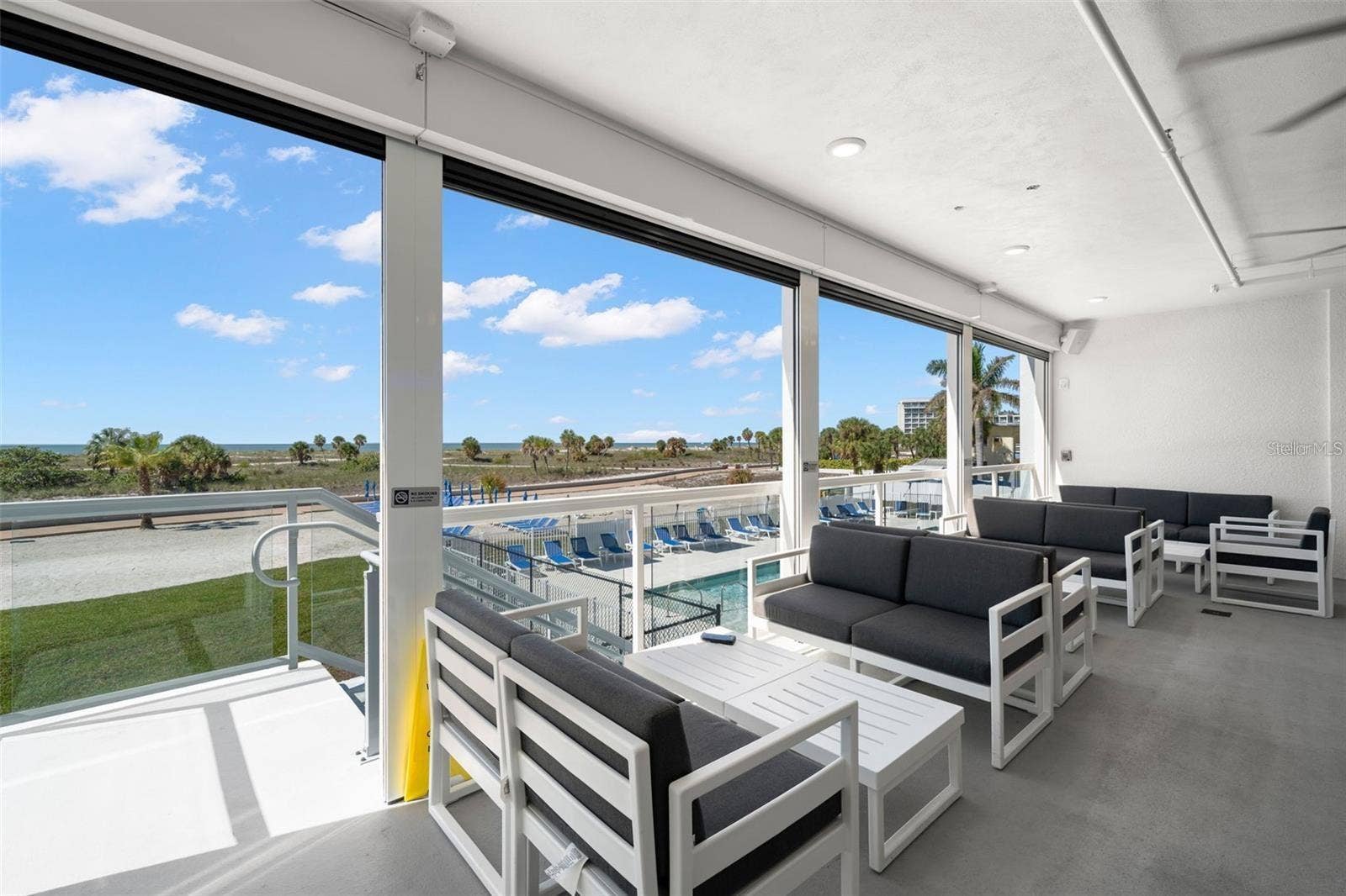 11500 GULF BOULEVARD, #304, Treasure Island, FL 33706 BAR LOUNGE AREA WITH STAIRS DOWN TO THE POOL DECK