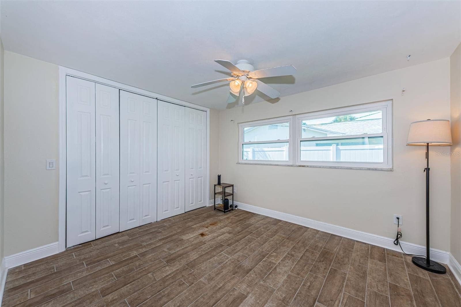 5230 VENETIAN BOULEVARD NE, St Petersburg, FL 33703 Bedroom 2 has pretty wood-look porcelain tile