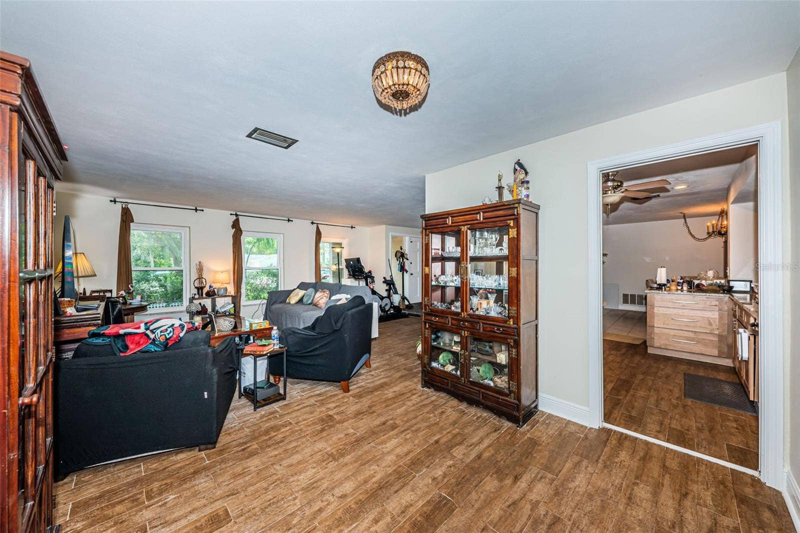 5230 VENETIAN BOULEVARD NE, St Petersburg, FL 33703 L-shaped living room with what was the dining space