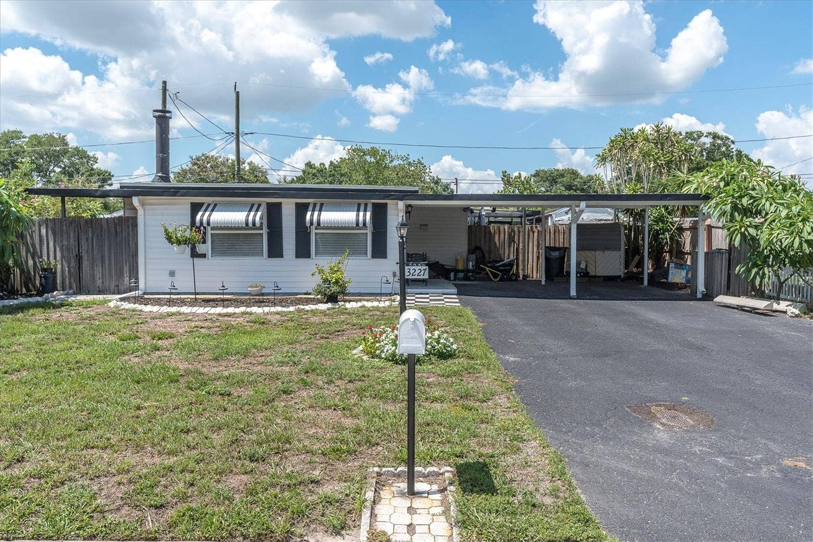 3227 48TH AVENUE N, St Petersburg, FL 33714 Front Exterior with oversized driveway and carport