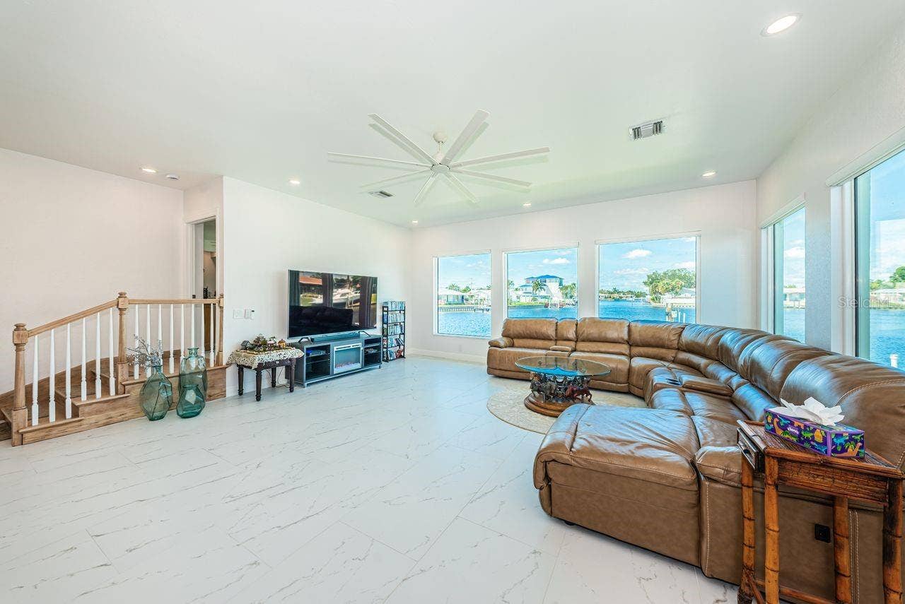 4280 13TH LANE NE, St Petersburg, FL 33703 Five big picture windows allow you to enjoy the water view. 3 small steps lead to primary bedroom.