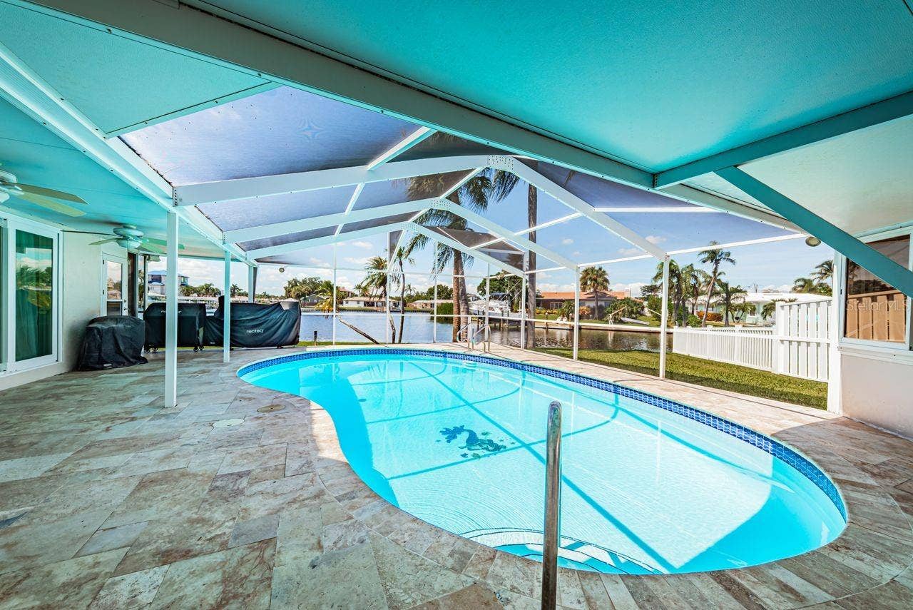 4280 13TH LANE NE, St Petersburg, FL 33703 Travertine pavers surround the pool