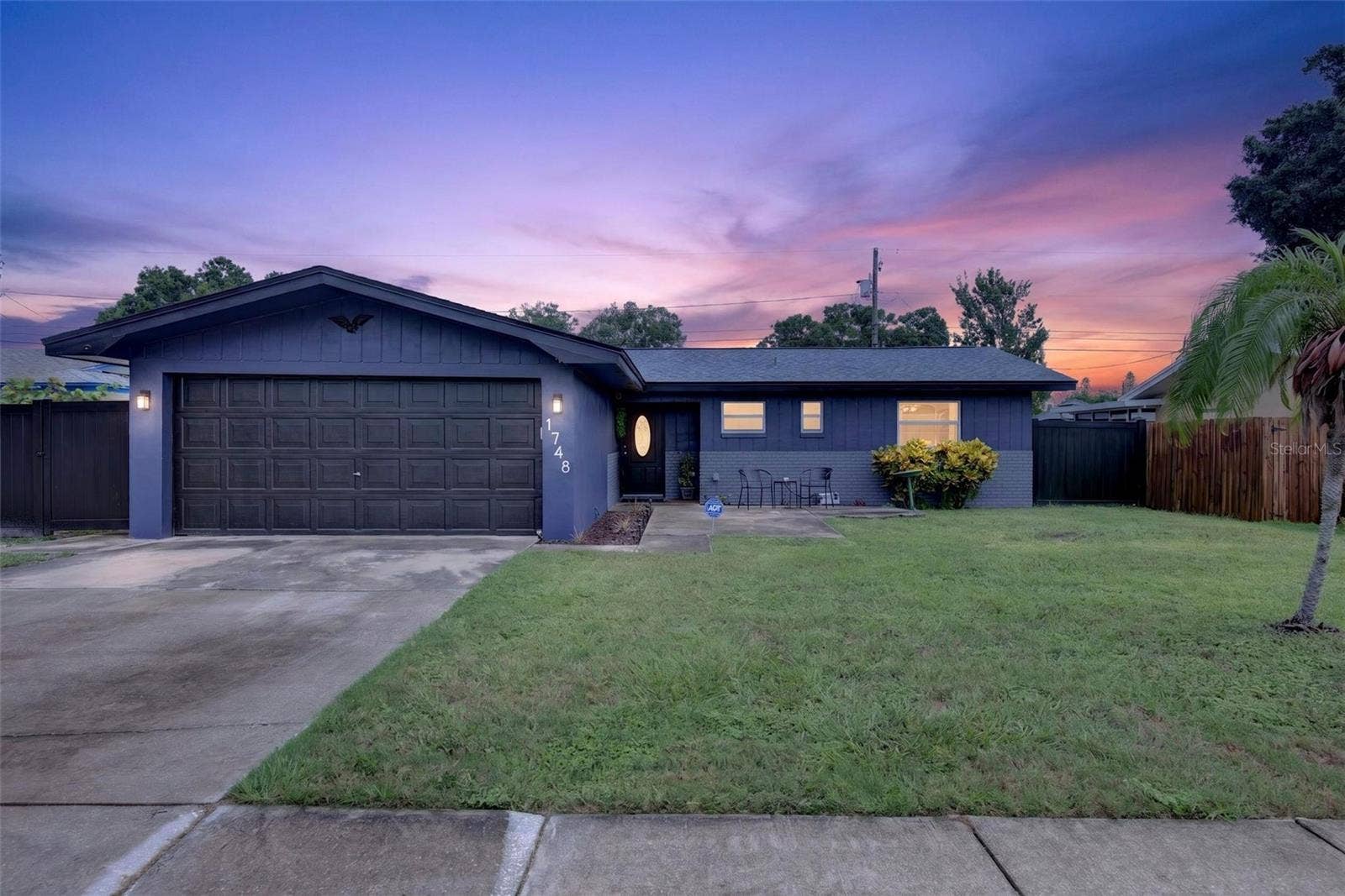 1748 GREENLEA DRIVE, Clearwater, FL 33755 Twilight photo of front of 1748 Greenlea. Check out the new navy blue paint colors on the exterior.