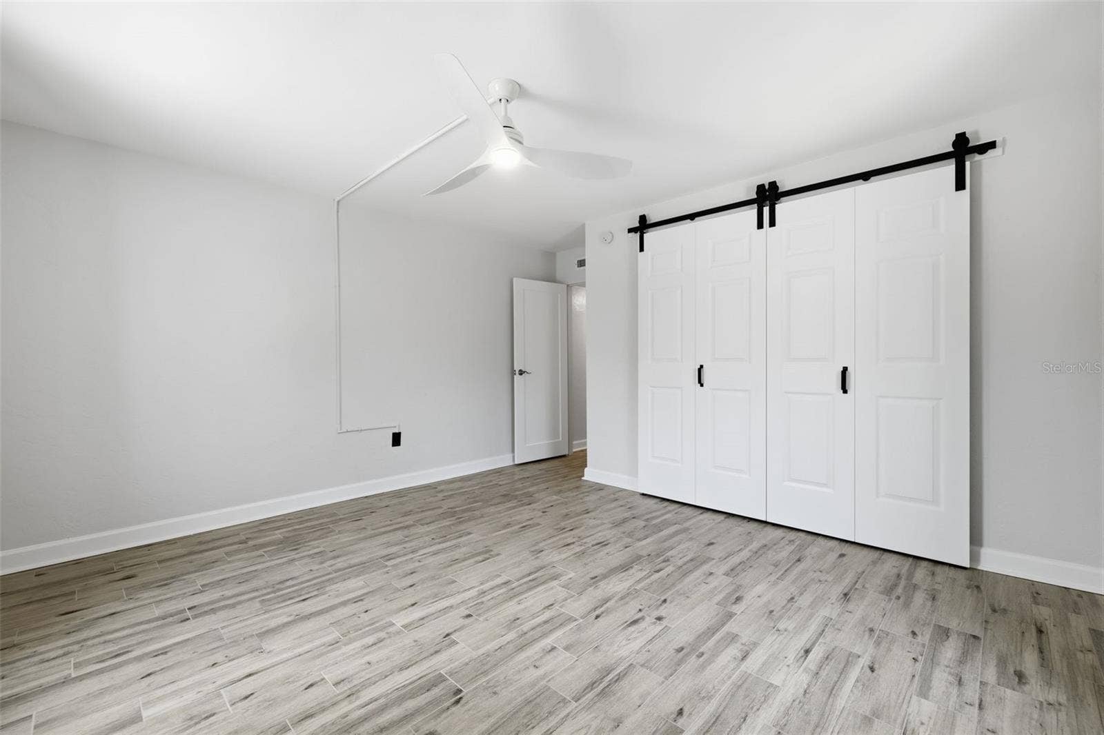 841 4TH AVENUE N, #27, St Petersburg, FL 33701 The primary bedroom includes a generously sized closet with an updated sliding door.