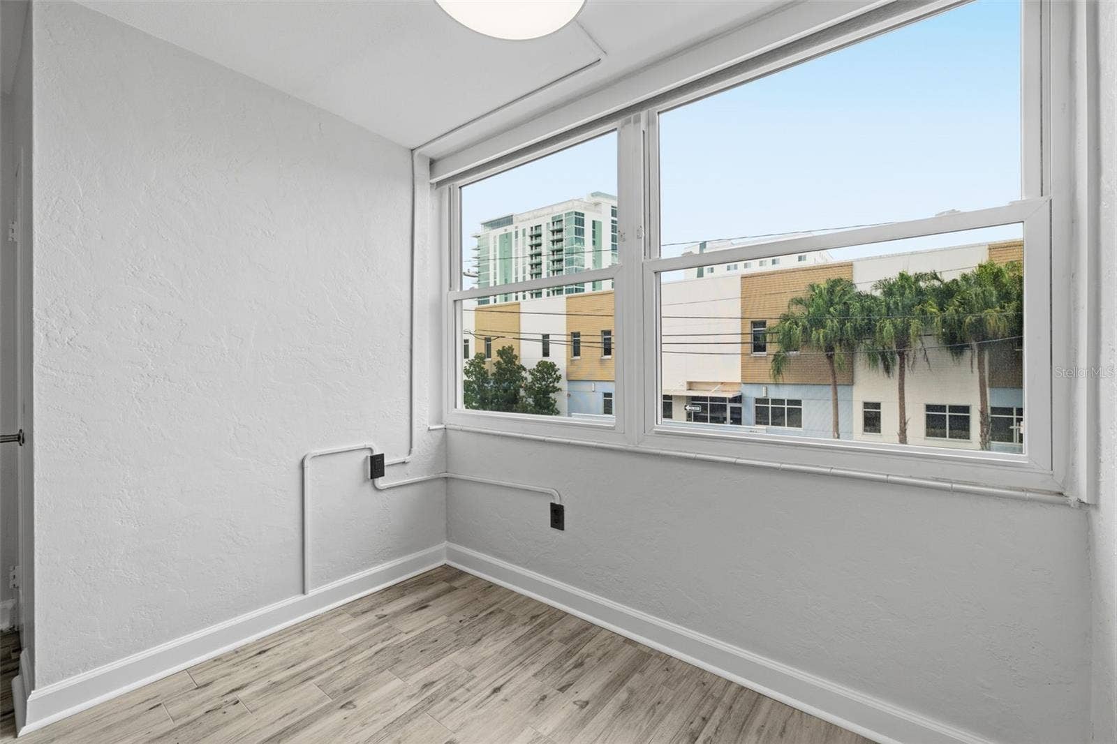 841 4TH AVENUE N, #27, St Petersburg, FL 33701 Natural light fills the living space through the new living room window, complete with convenient electric blinds.