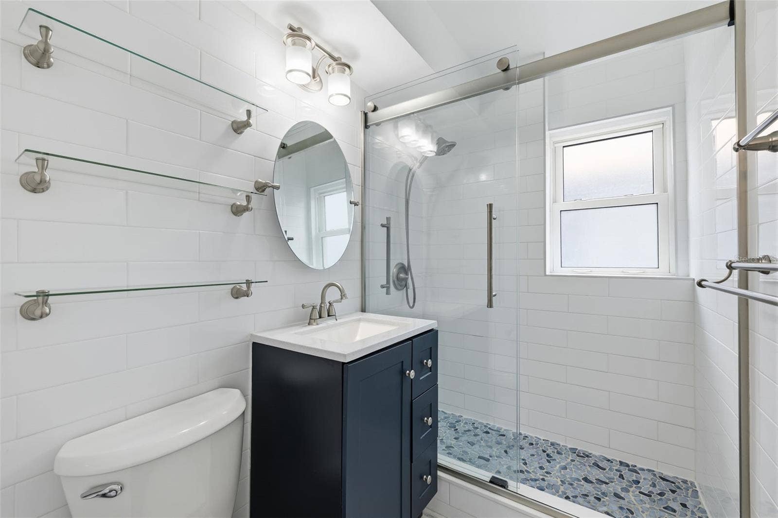 841 4TH AVENUE N, #27, St Petersburg, FL 33701 Fully updated bathroom with a fresh, modern design and beautifully finished shower.