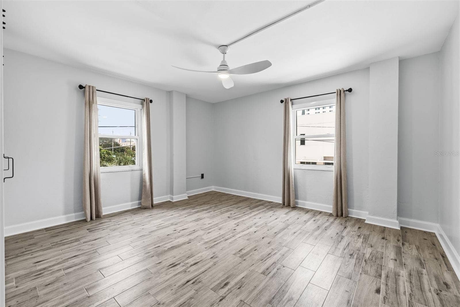 841 4TH AVENUE N, #27, St Petersburg, FL 33701 The spacious bedroom features multiple windows, newer tile flooring, and a ceiling fan for added comfort.
