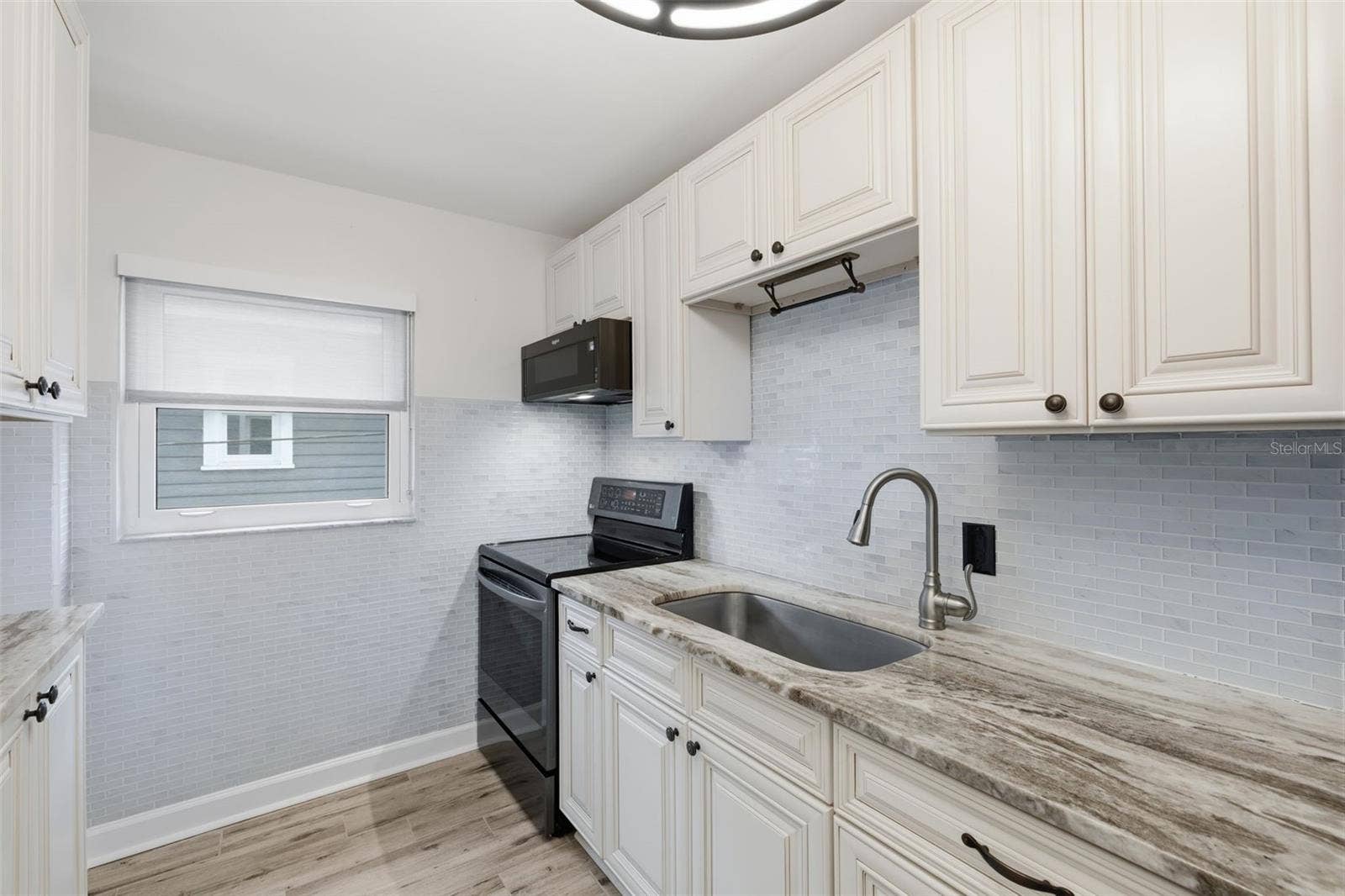 841 4TH AVENUE N, #27, St Petersburg, FL 33701 The refreshed kitchen features newer finishes, updated tile, and a window that brings natural light into the space.