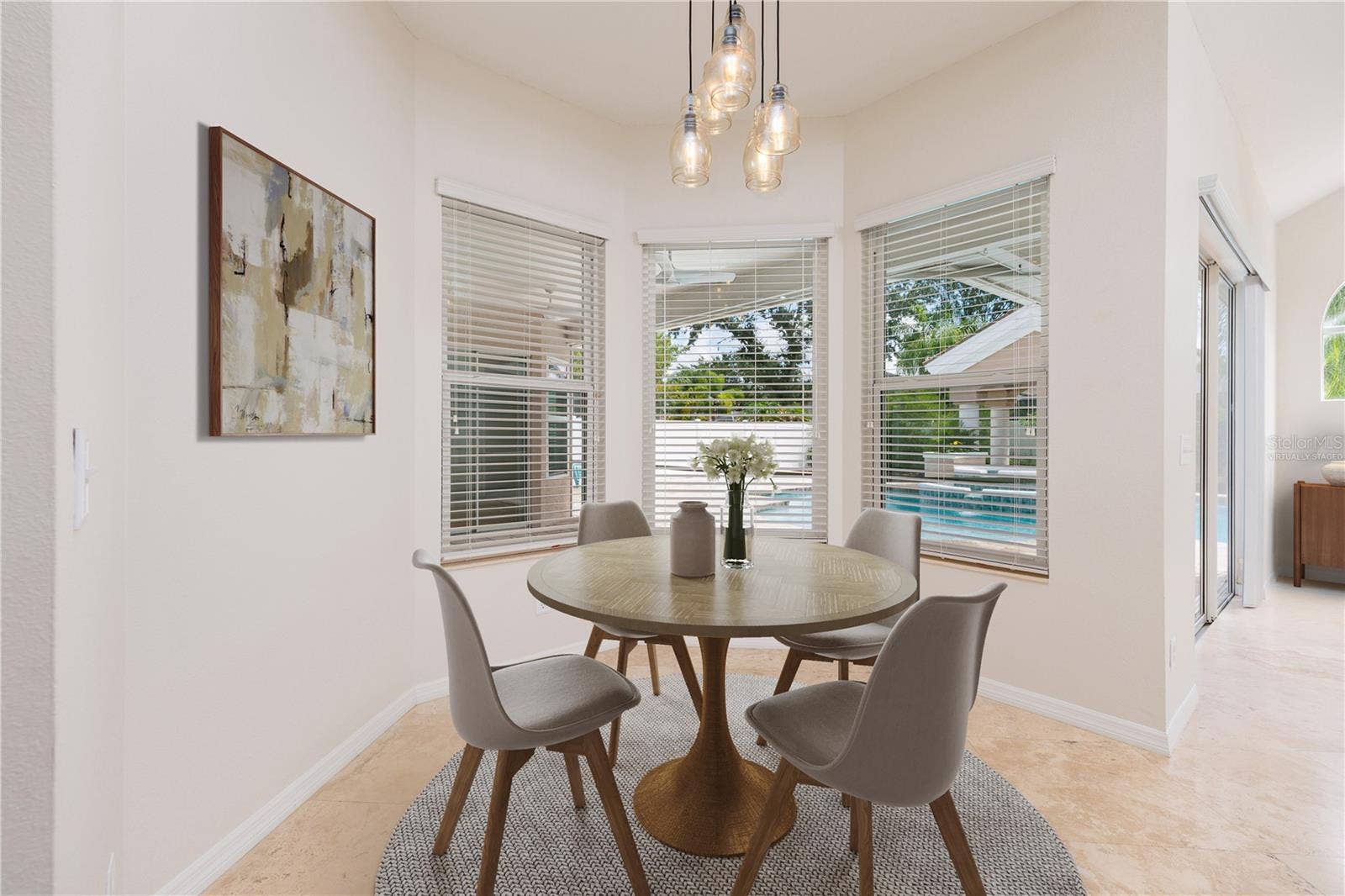 Virtually staged breakfast area overlooking pool
