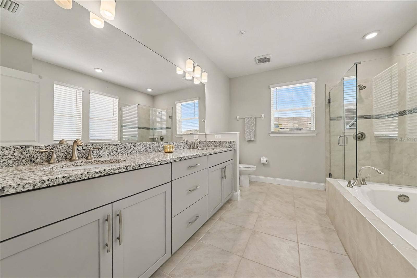 7505 LAUREATE BOULEVARD, #2407, Orlando, FL 32827 Primary Bedroom Ensuite Bathroom with separate deep tub, oversized shower, dual sink vanity, and linen closet