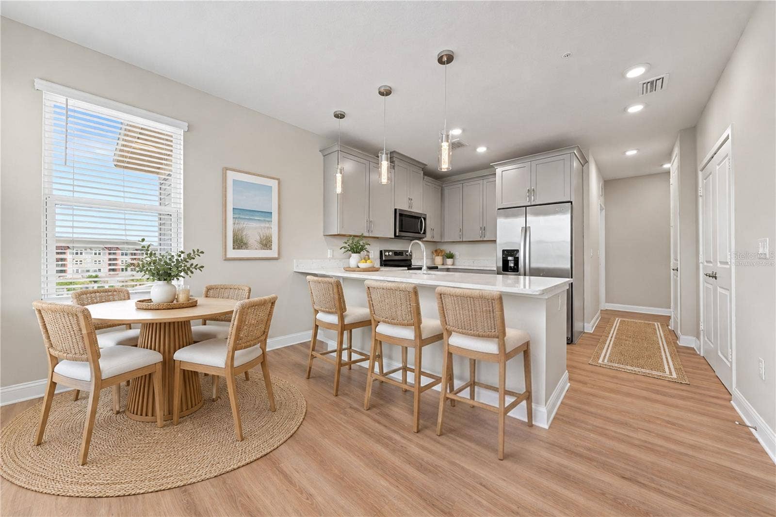 7505 LAUREATE BOULEVARD, #2407, Orlando, FL 32827 Virtually staged kitchen with table and counter stools