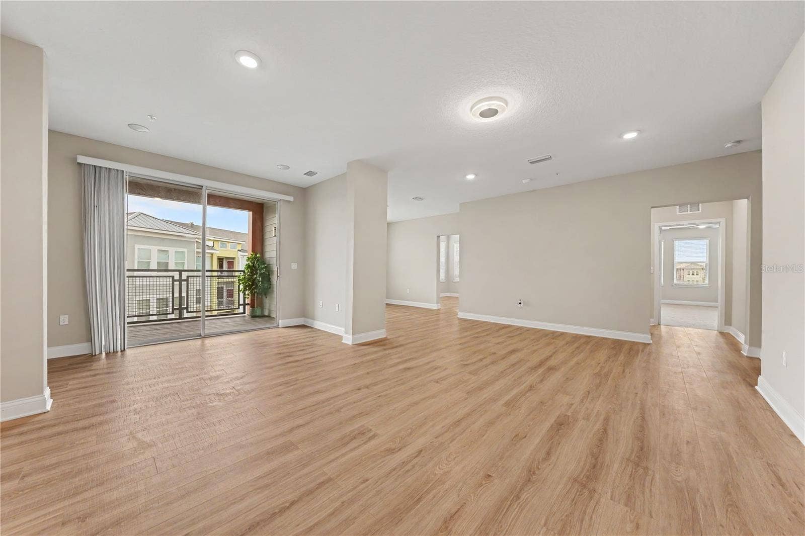 7505 LAUREATE BOULEVARD, #2407, Orlando, FL 32827 A great room with luxury vinyl flooring and an abundance of room for designing your space