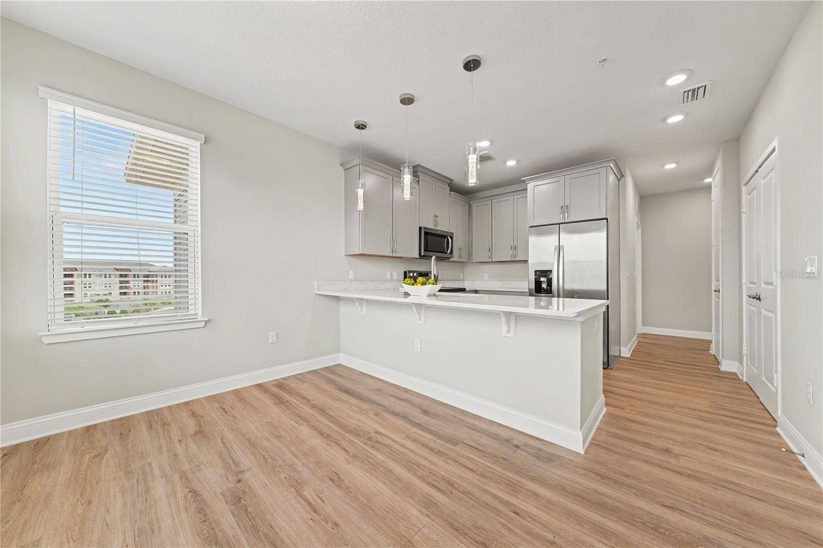 7505 LAUREATE BOULEVARD, #2407, Orlando, FL 32827 Upgrades through the condo, including stainless steel appliances, pendant lighting, pantry, and additional lighting