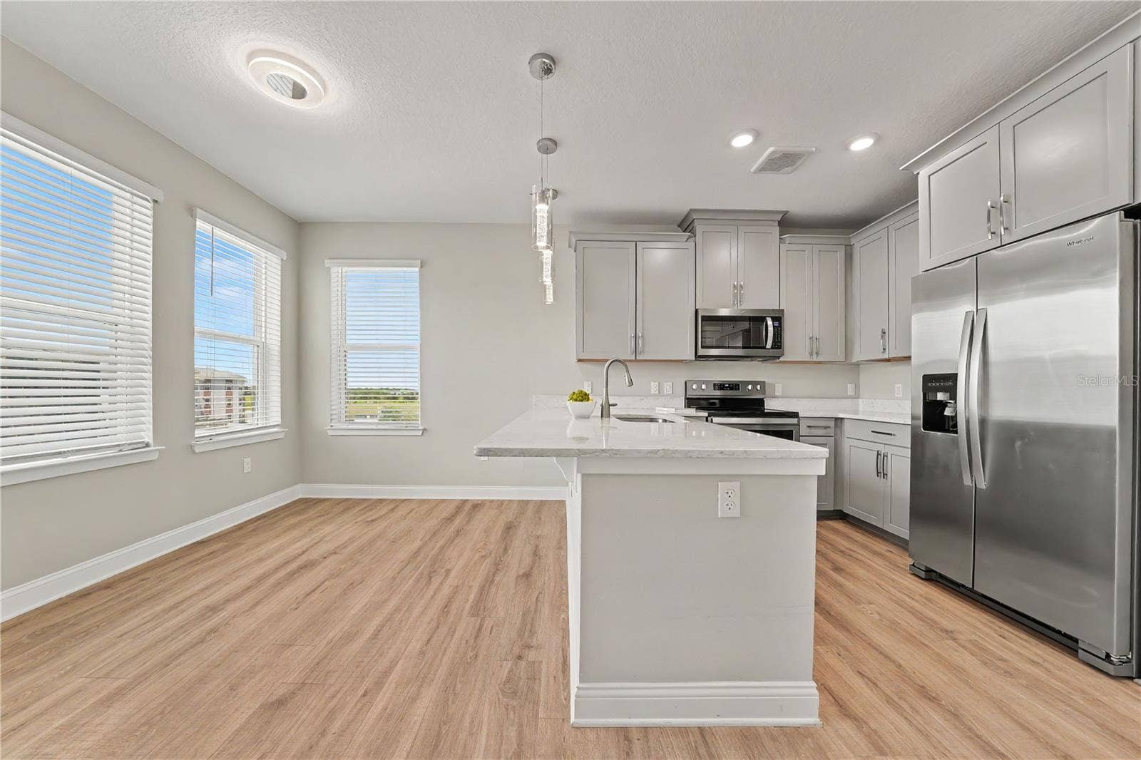 7505 LAUREATE BOULEVARD, #2407, Orlando, FL 32827 Eat in space in the kitchen with counter height bar and 4 windows streaming Florida sunshine and breezes!