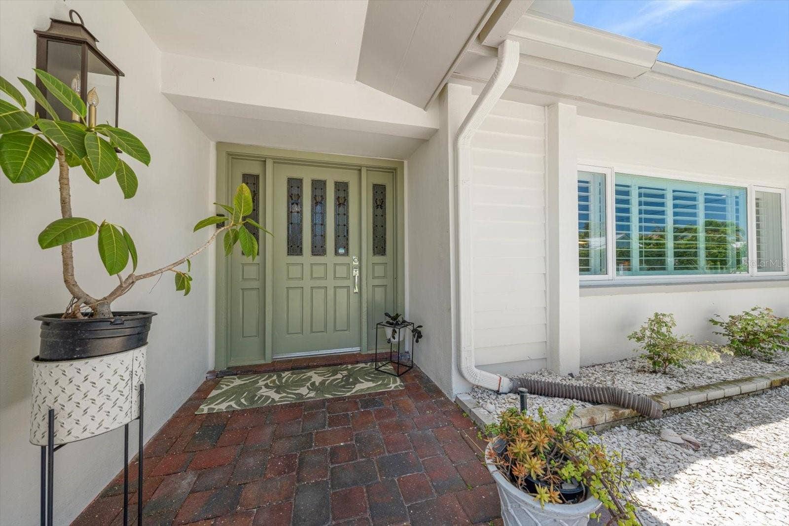 Beautiful entryway! Key West style shutters on the windows.