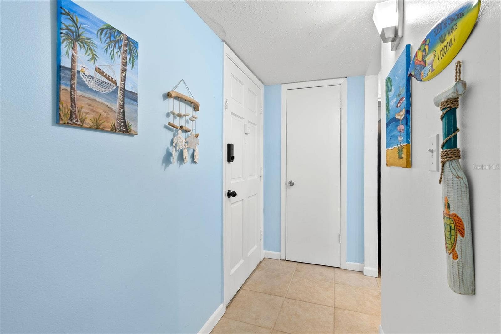 12760 INDIAN ROCKS ROAD, #107, Largo, FL 33774 The tiled foyer creates a defined entry into the condo, with the front door opening to a compact hall that leads directly toward the kitchen and main living areas.