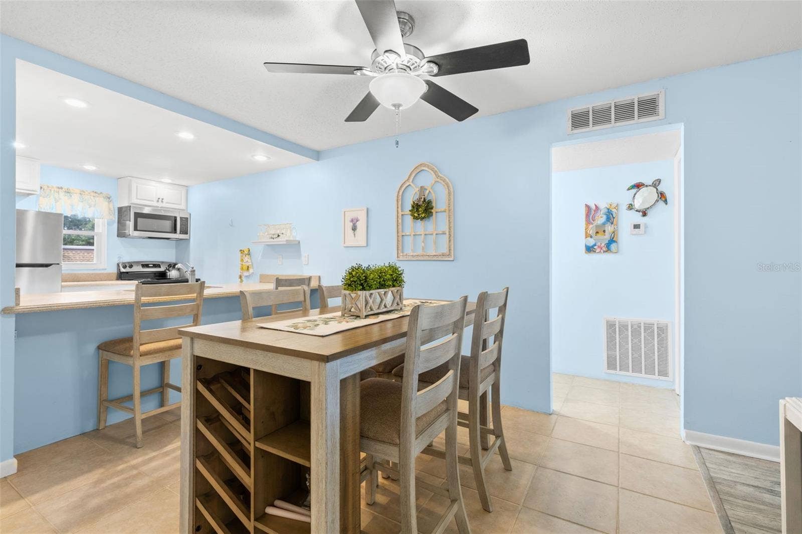 12760 INDIAN ROCKS ROAD, #107, Largo, FL 33774 The dining area sits between the kitchen and bedroom hallway, with tile flooring, a ceiling fan and the breakfast bar just steps away for additional seating.