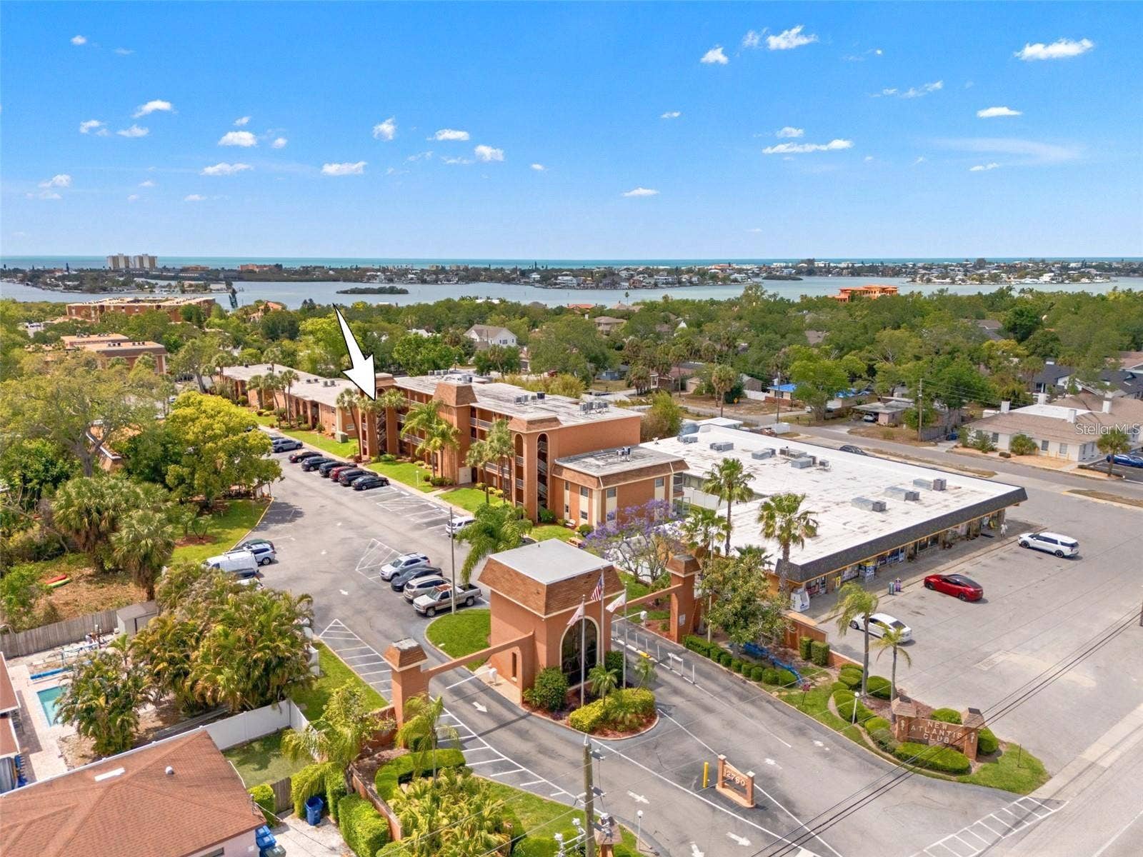 12760 INDIAN ROCKS ROAD, #107, Largo, FL 33774 The landscaped entrance to New Atlantis Club creates a defined arrival, with a gated entry, tropical plantings and the communitys signature architectural details setting the tone from the start.