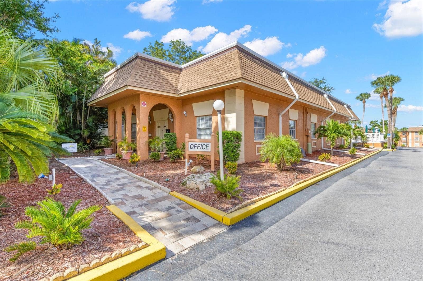 12760 INDIAN ROCKS ROAD, #107, Largo, FL 33774 Within the community, the on-site office is surrounded by tropical landscaping and a paved walkway, adding another convenient touch to the New Atlantis Club setting.