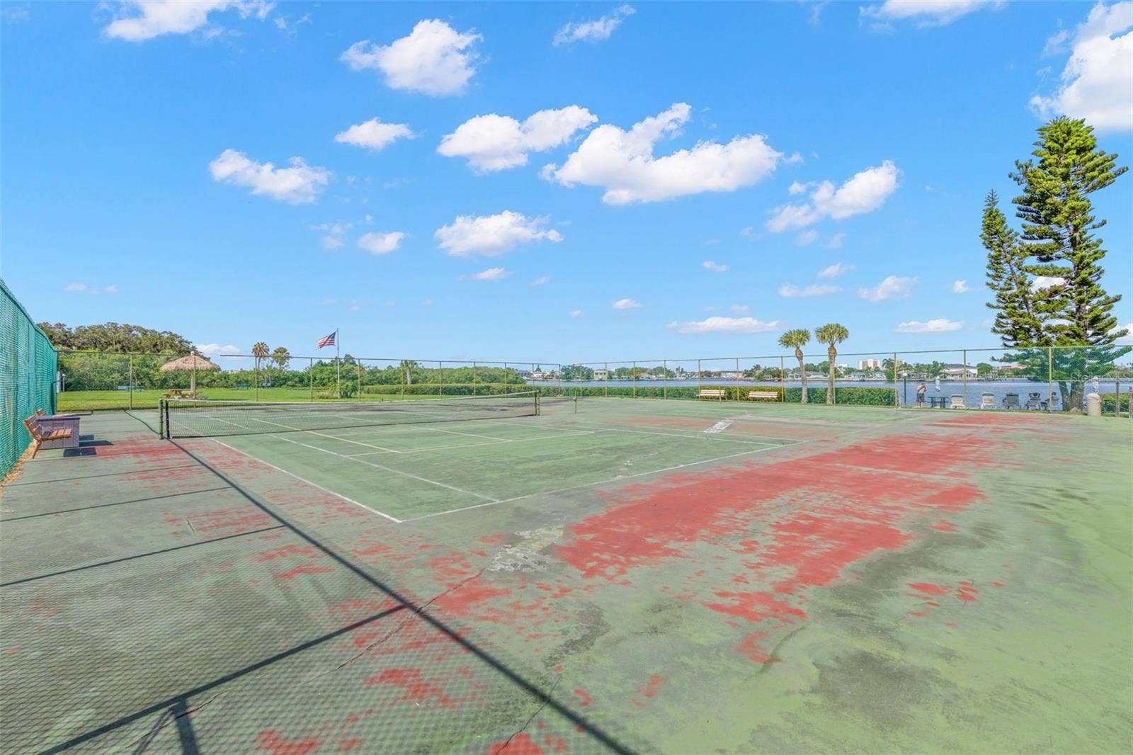12760 INDIAN ROCKS ROAD, #107, Largo, FL 33774 The community tennis courts sit beside the water, pairing another recreational amenity with open views across the surrounding mangroves and Intracoastal setting.