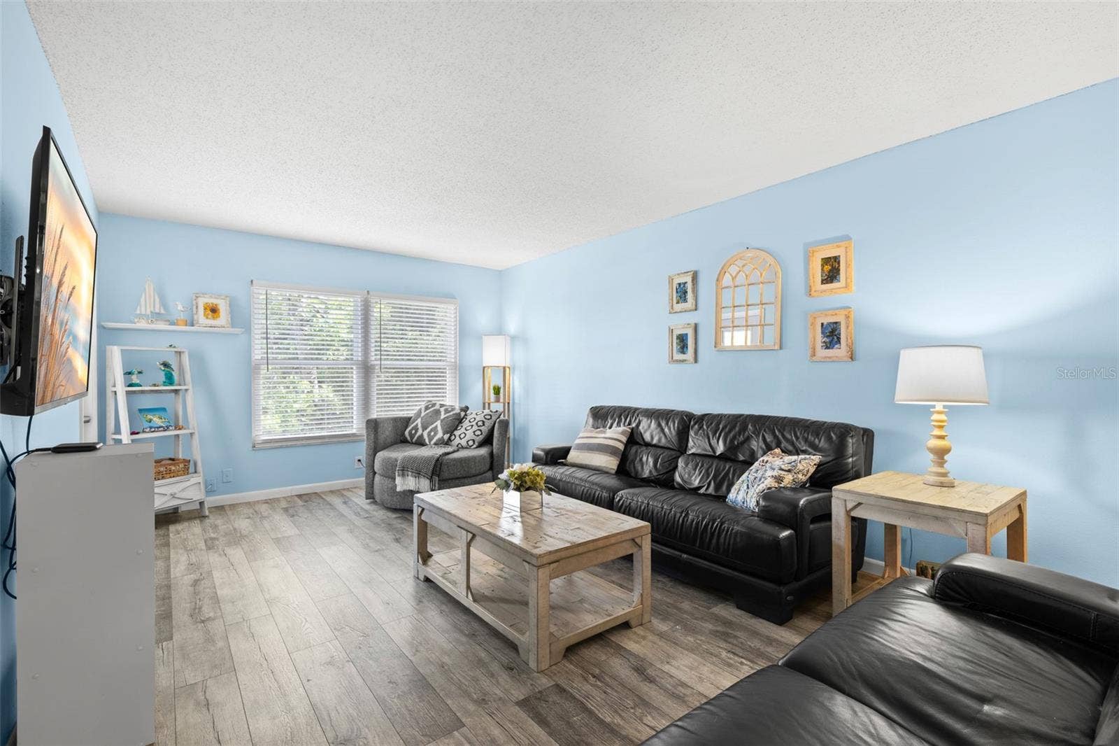 12760 INDIAN ROCKS ROAD, #107, Largo, FL 33774 The 20-foot living room offers plenty of space for a full seating arrangement, with luxury vinyl flooring and a wide bank of windows drawing natural light across the room.