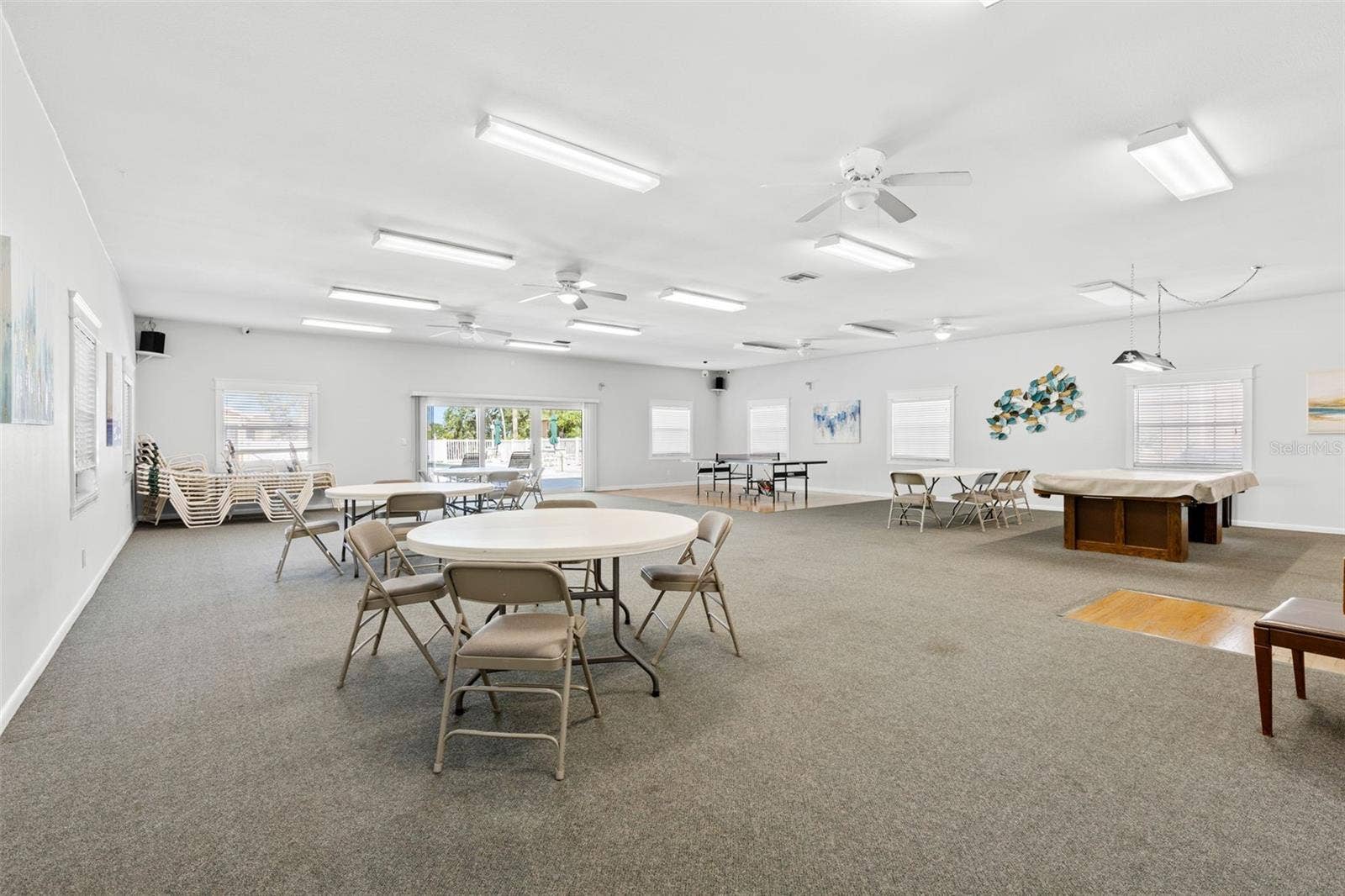 12760 INDIAN ROCKS ROAD, #107, Largo, FL 33774 The clubhouse provides plenty of room to gather, with multiple tables for cards or games, billiards and ping-pong, plus doors opening toward the pool area.