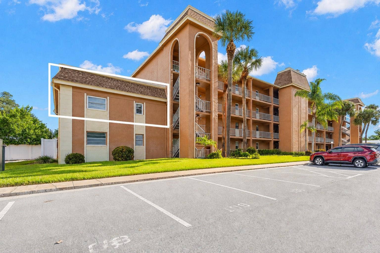 12760 INDIAN ROCKS ROAD, #107, Largo, FL 33774 Tucked into the end section of the building, the outlined residence enjoys a more private position with no neighbors above, while mature palms and landscaped grounds frame the community setting.