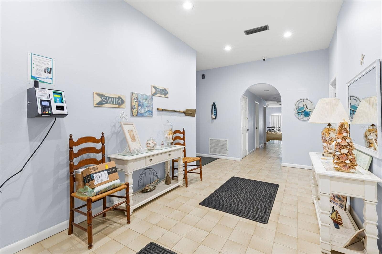 12760 INDIAN ROCKS ROAD, #107, Largo, FL 33774 The clubhouse entry hall is finished with tile flooring and recessed lighting, with a welcoming coastal theme and easy access to the communitys gathering and recreation spaces beyond.