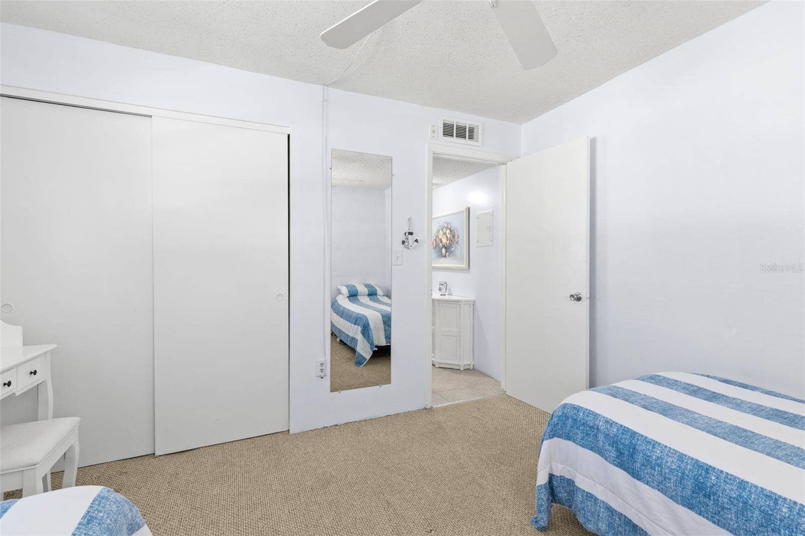 12760 INDIAN ROCKS ROAD, #107, Largo, FL 33774 Bedroom 2 includes a built-in closet with sliding doors, neutral carpet and convenient access to the hall and nearby bath.