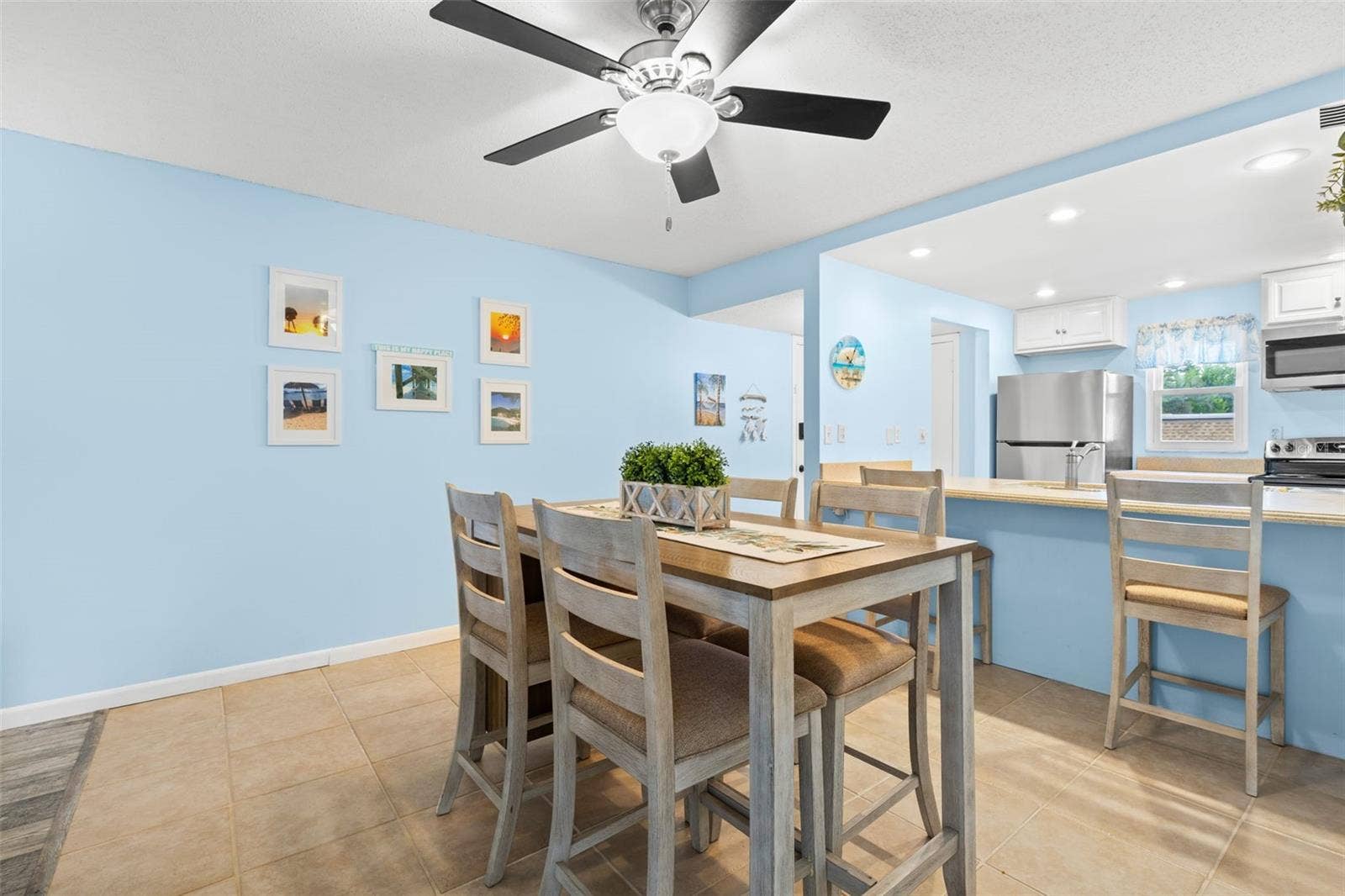 12760 INDIAN ROCKS ROAD, #107, Largo, FL 33774 The dining area sits just beyond the kitchen, with tile flooring, a ceiling fan overhead and enough room for a full dining set, while the breakfast bar adds extra seating along the kitchen edge.