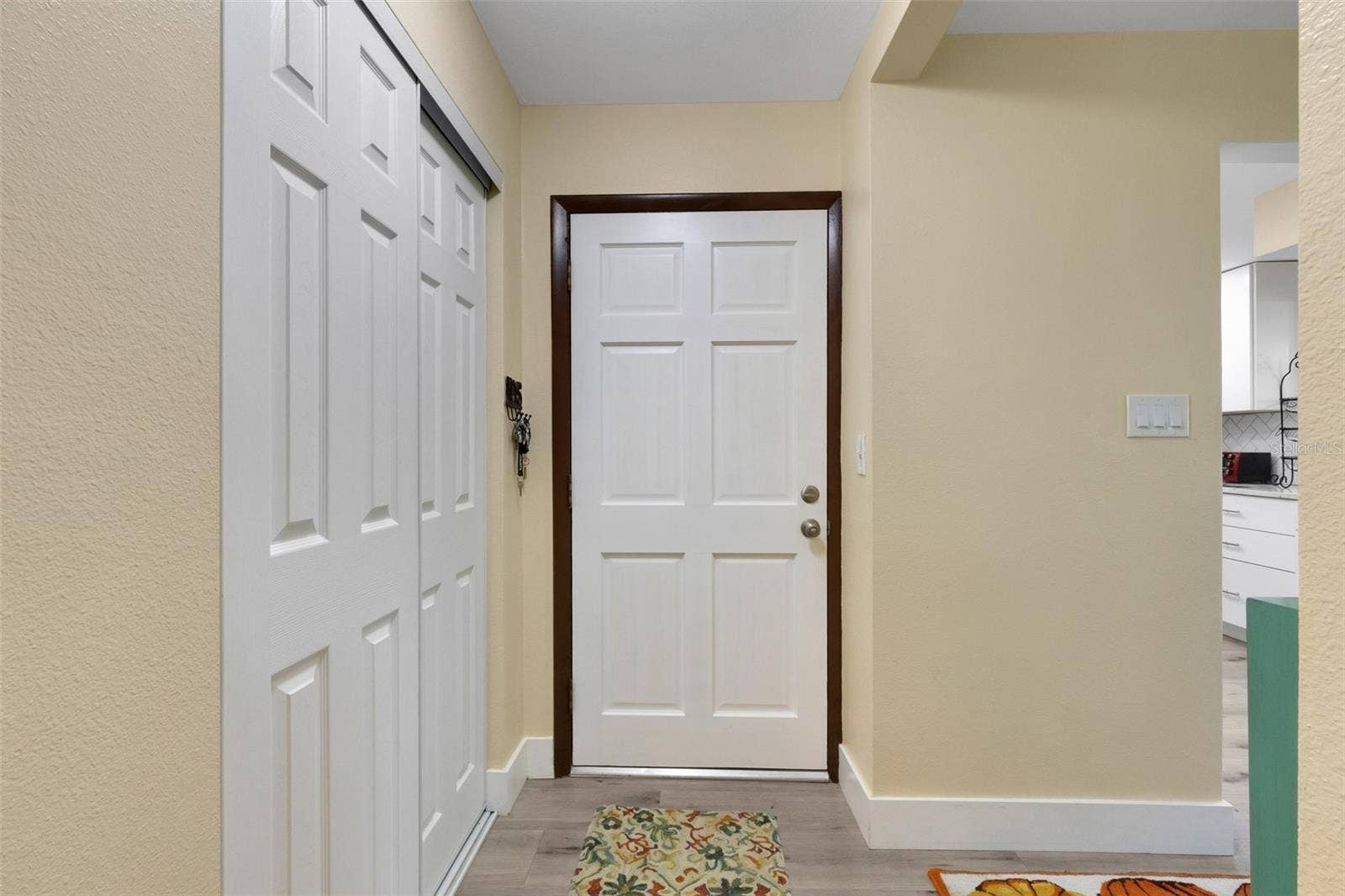 Entryway with Kitchen and Living Areas to the Right