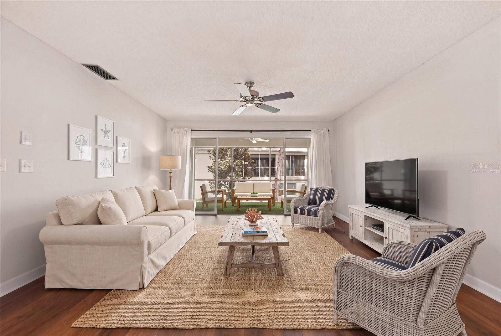 1975 W BAY DRIVE, #109, Largo, FL 33770 Living room with sliding glass to screened in lanai. Virtually staged.