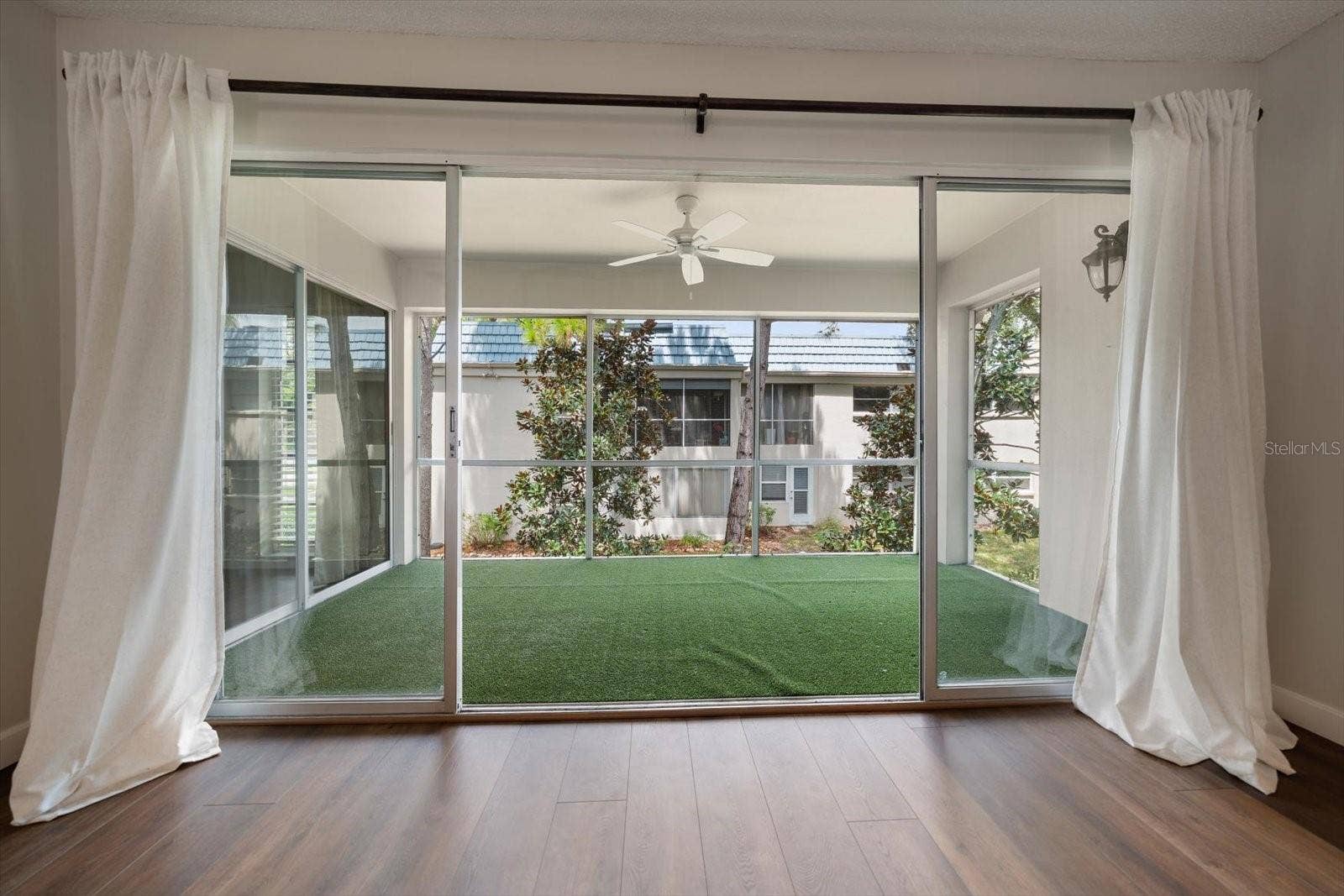 1975 W BAY DRIVE, #109, Largo, FL 33770 Living room with sliding glass doors to screened lanai