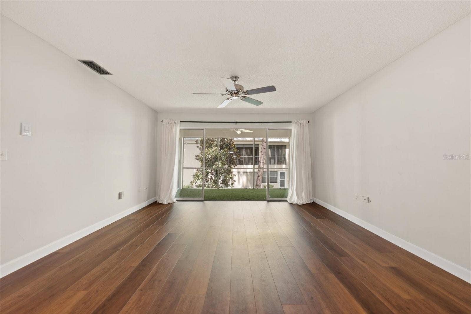 1975 W BAY DRIVE, #109, Largo, FL 33770 Open plan dining room, living room and sliding glass doors to screened in lanai