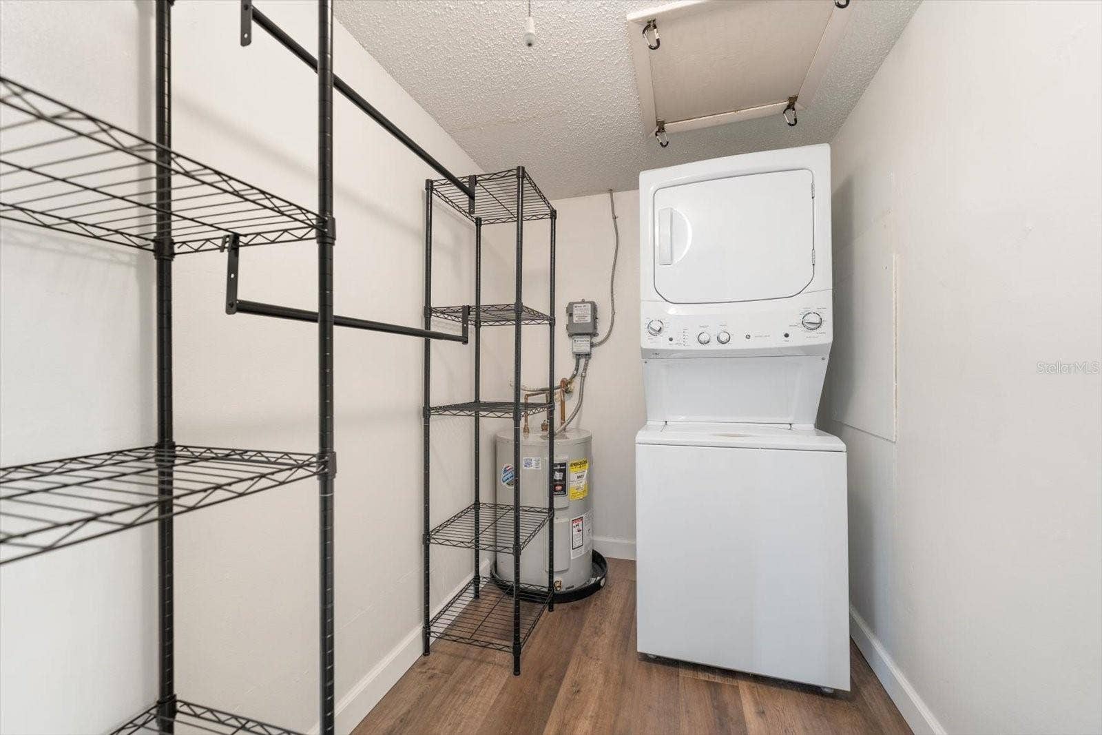 1975 W BAY DRIVE, #109, Largo, FL 33770 Primary bedroom walk in closet with GE washer/dryer