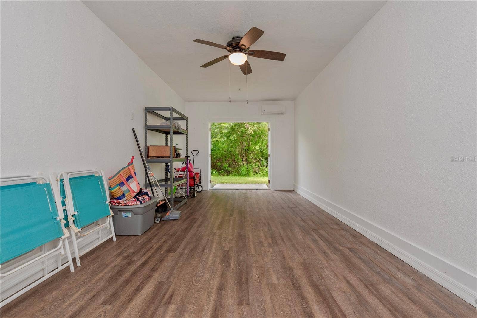 5065 ROYAL PALMS WAY, #303, New Port Richey, FL 34652 Downstairs storage room has French doors leading to a small patio and has a tree view.