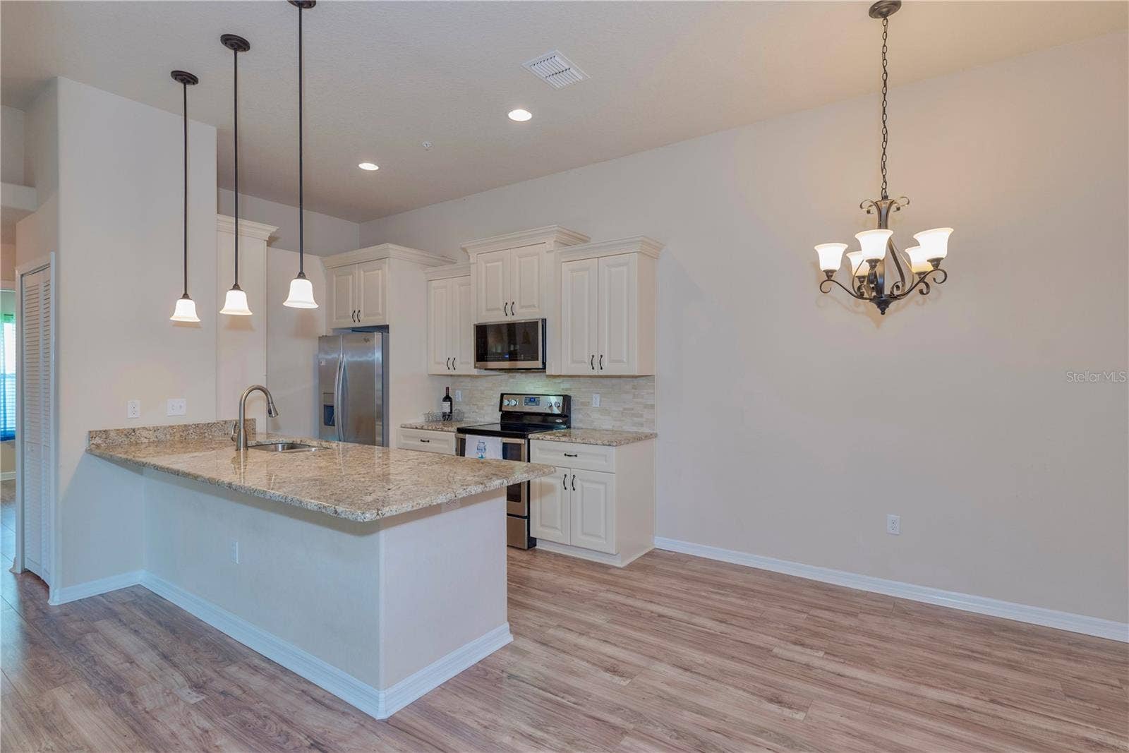 5065 ROYAL PALMS WAY, #303, New Port Richey, FL 34652 Kitchen and dining room.