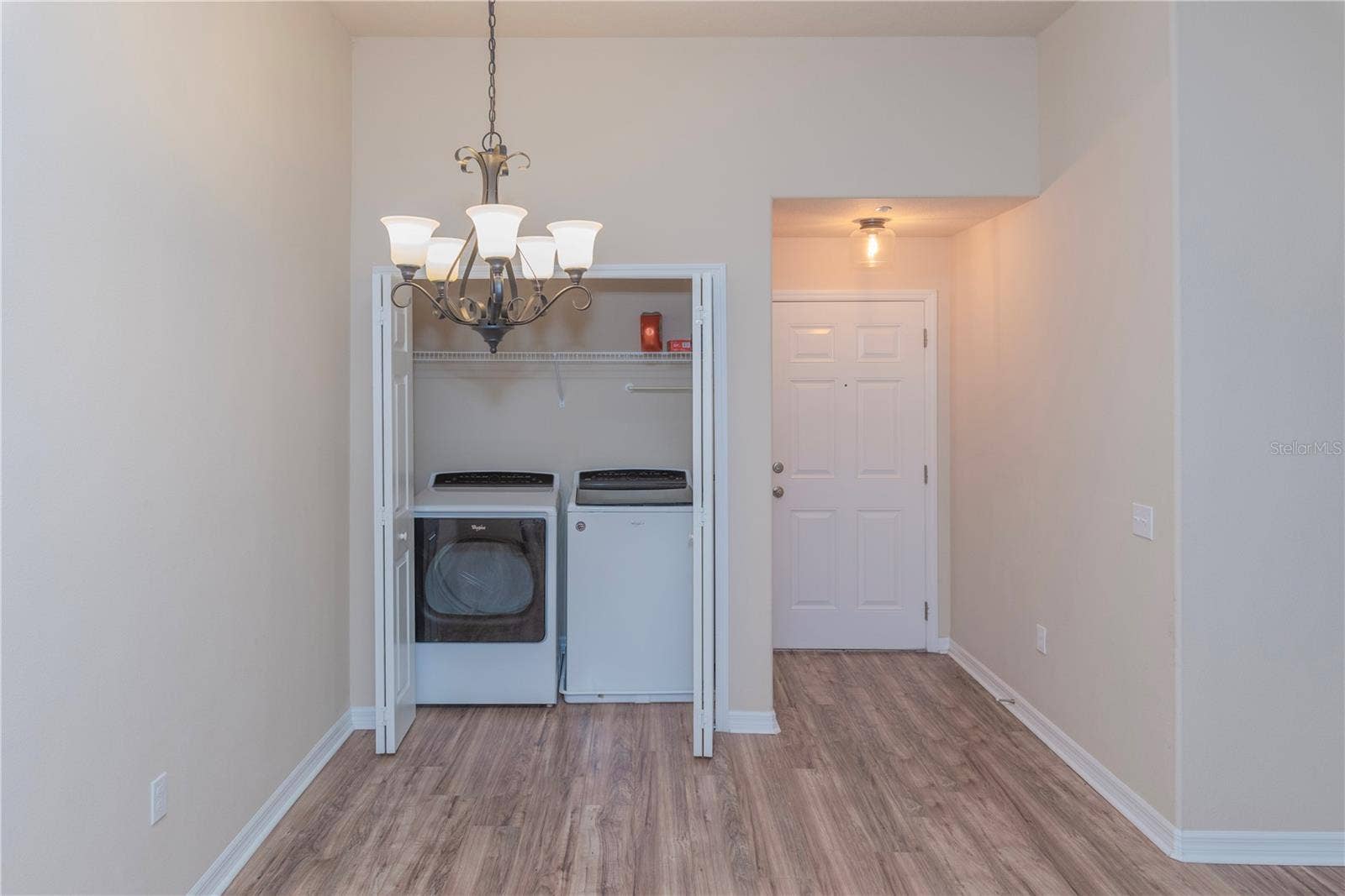 5065 ROYAL PALMS WAY, #303, New Port Richey, FL 34652 Laundry closet and dining room.