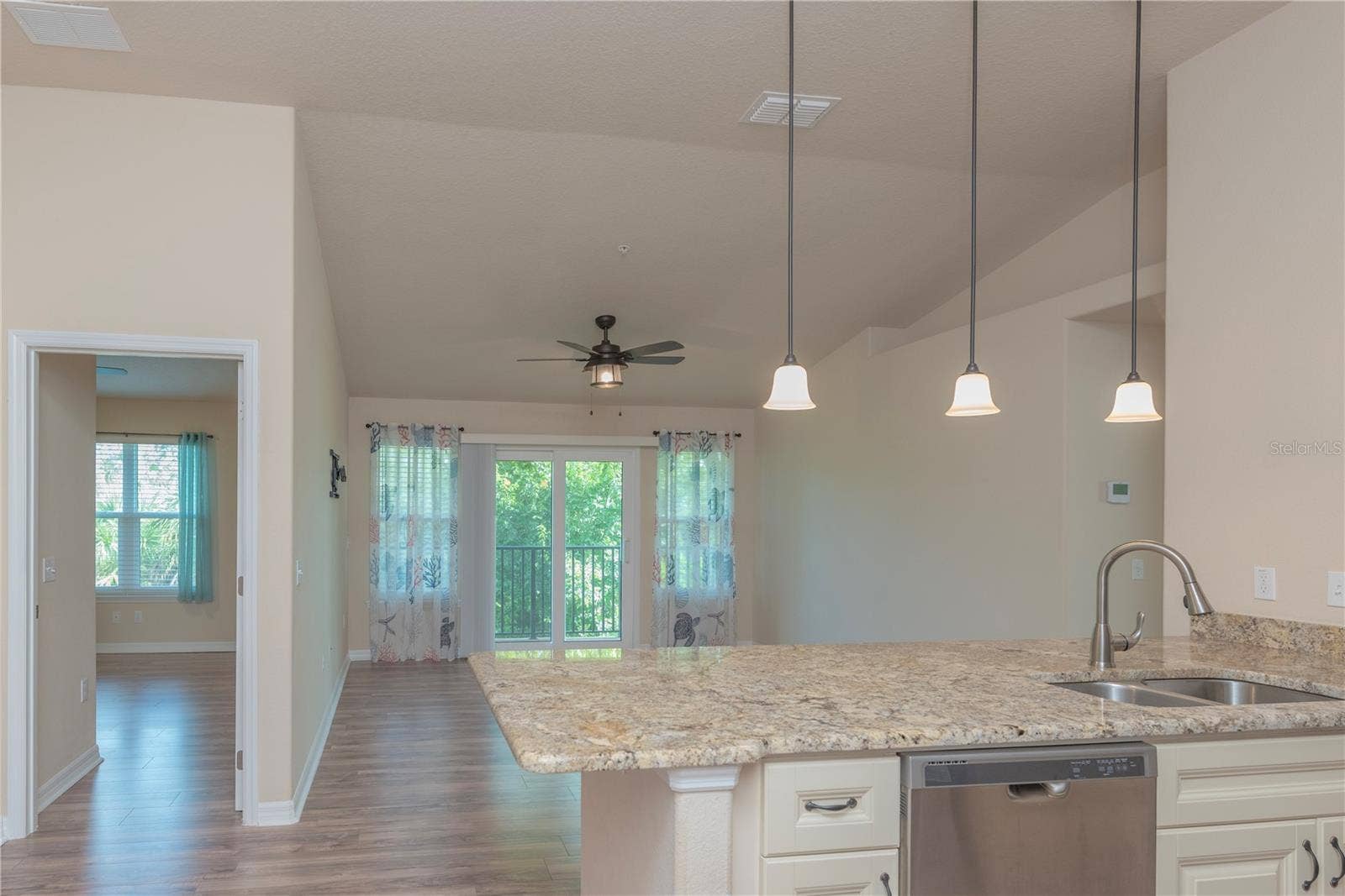 5065 ROYAL PALMS WAY, #303, New Port Richey, FL 34652 Kitchen and living room.