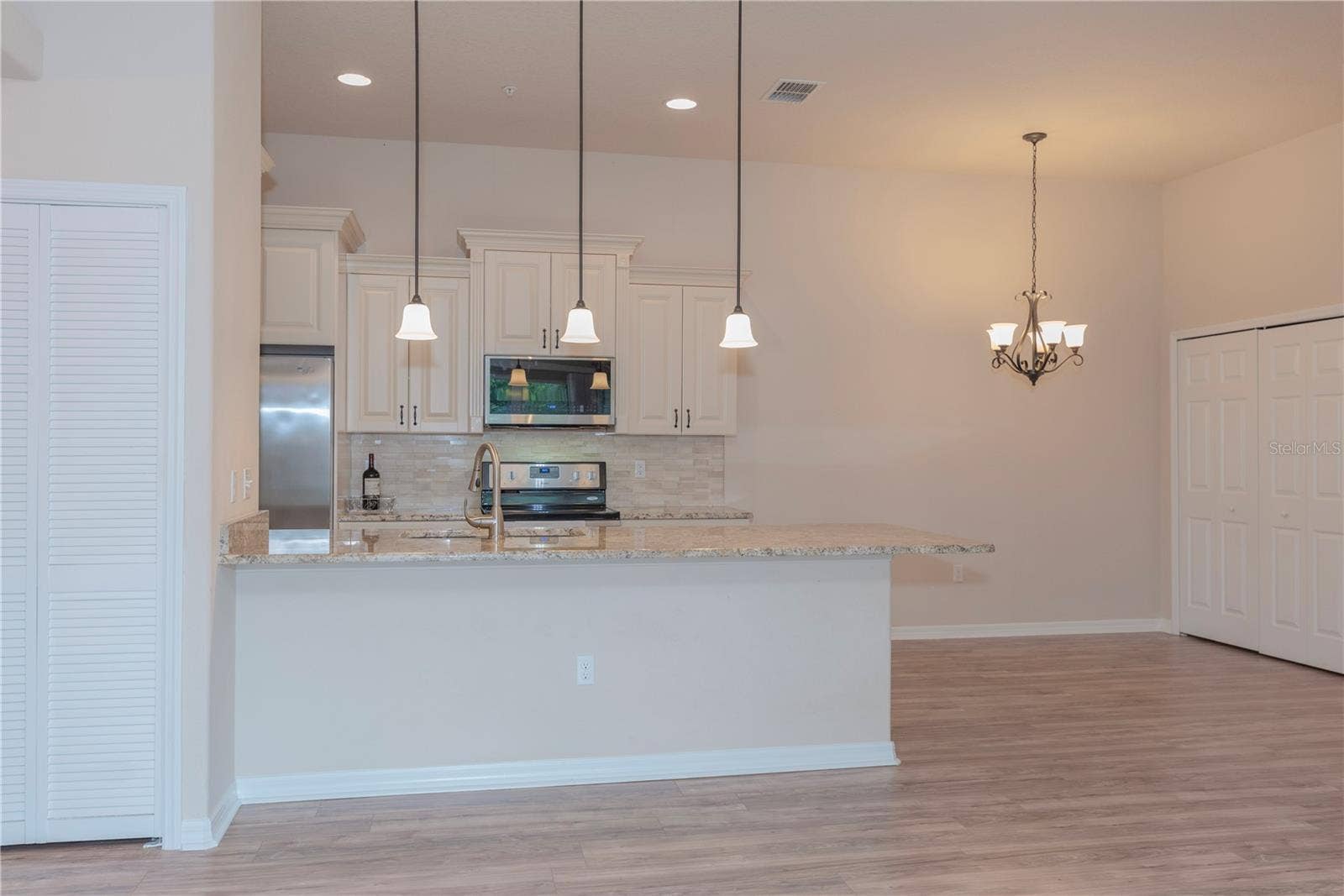 5065 ROYAL PALMS WAY, #303, New Port Richey, FL 34652 Breakfast bar between the kitchen and living room.
