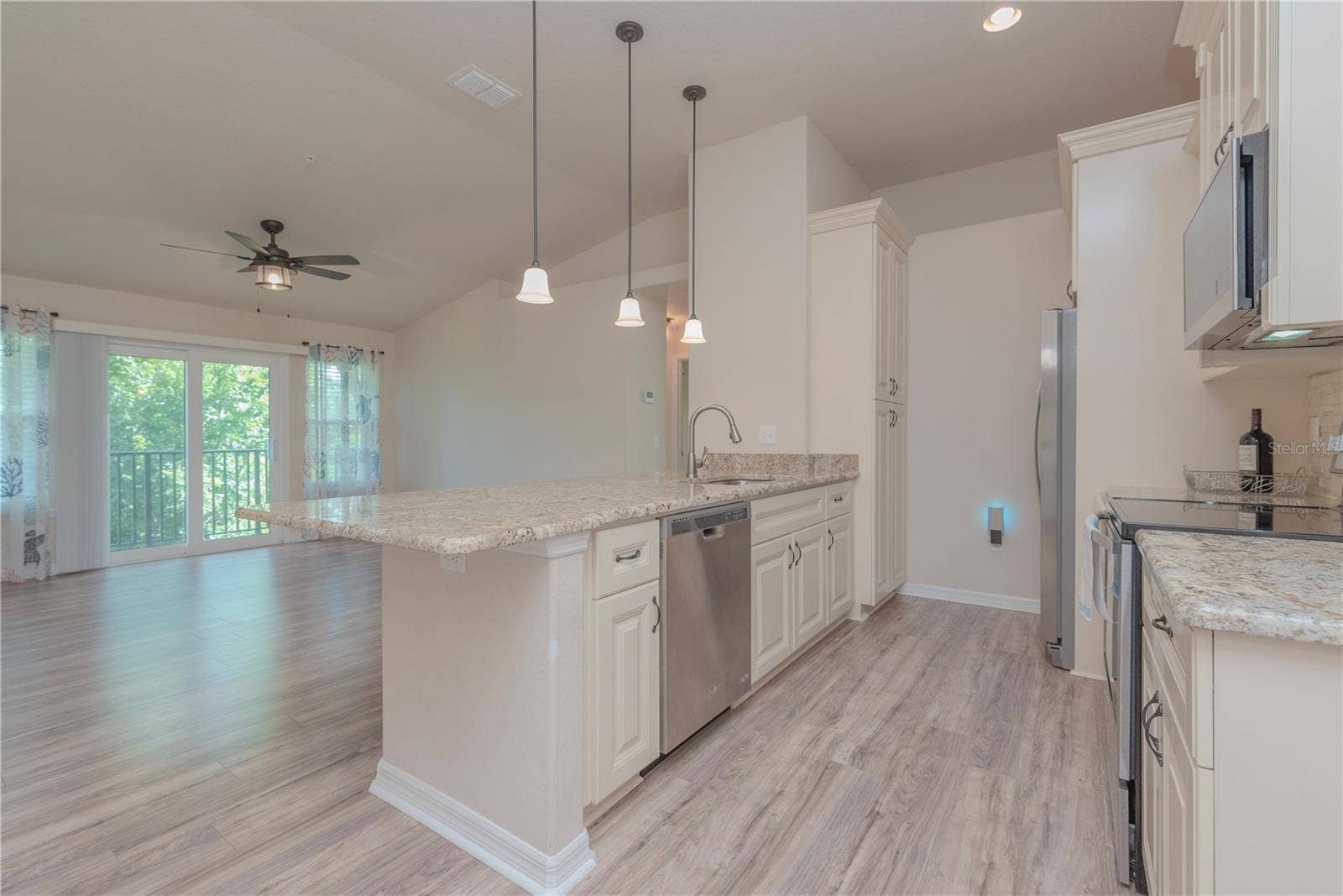 5065 ROYAL PALMS WAY, #303, New Port Richey, FL 34652 Kitchen with stainless steel appliances and closet pantry.