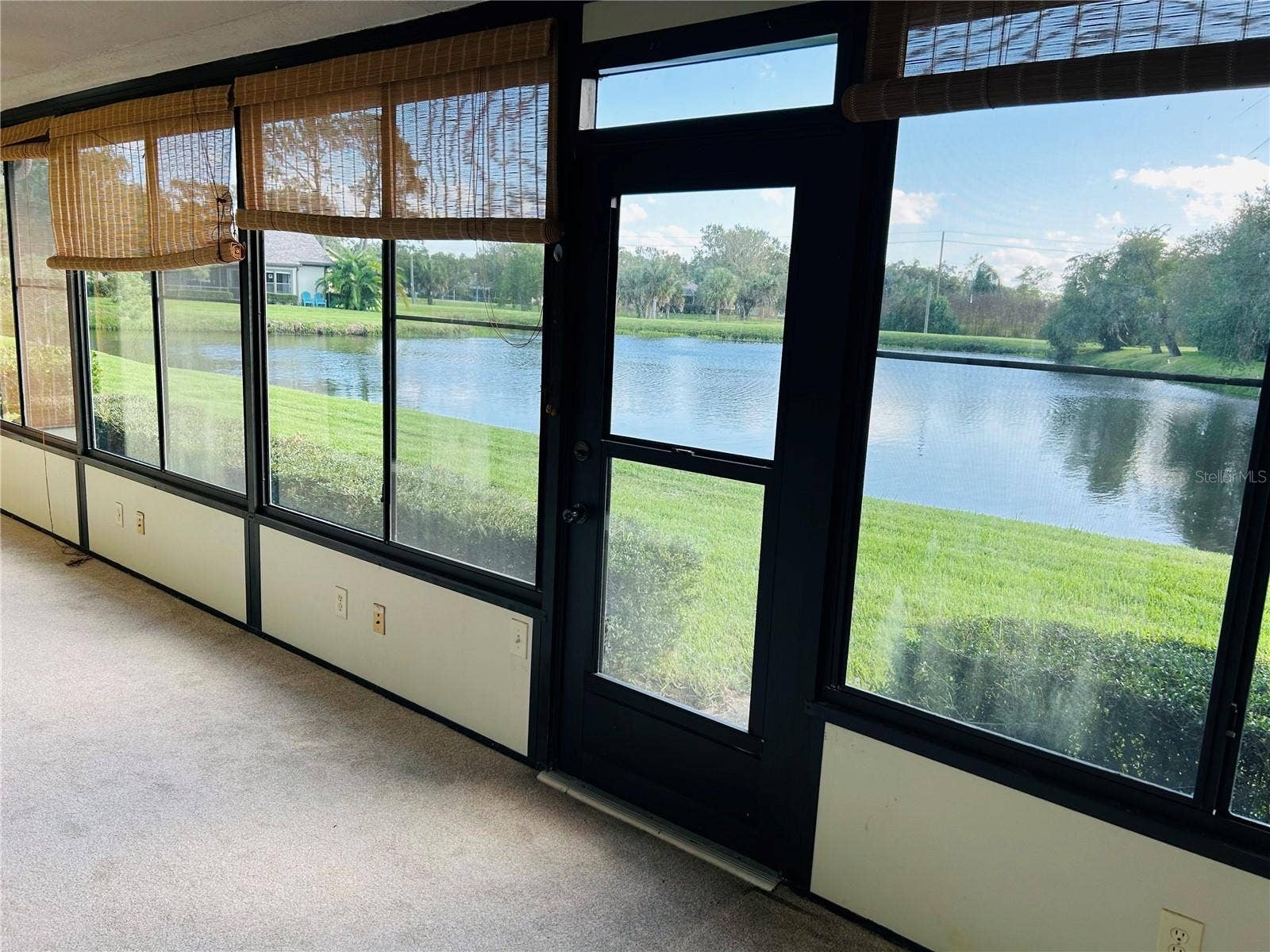60 KAY COURT, Oldsmar, FL 34677 Large enclosed florida room overlooking the pond