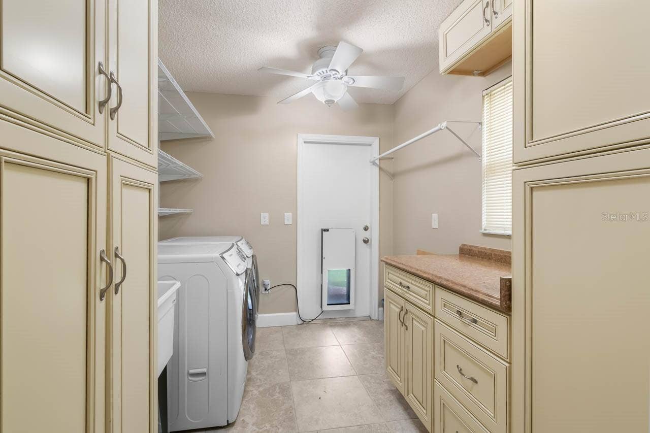 1519 FORT DUQUESNA DRIVE, Sun City Center, FL 33573 Laundry room with doggy door to the yard