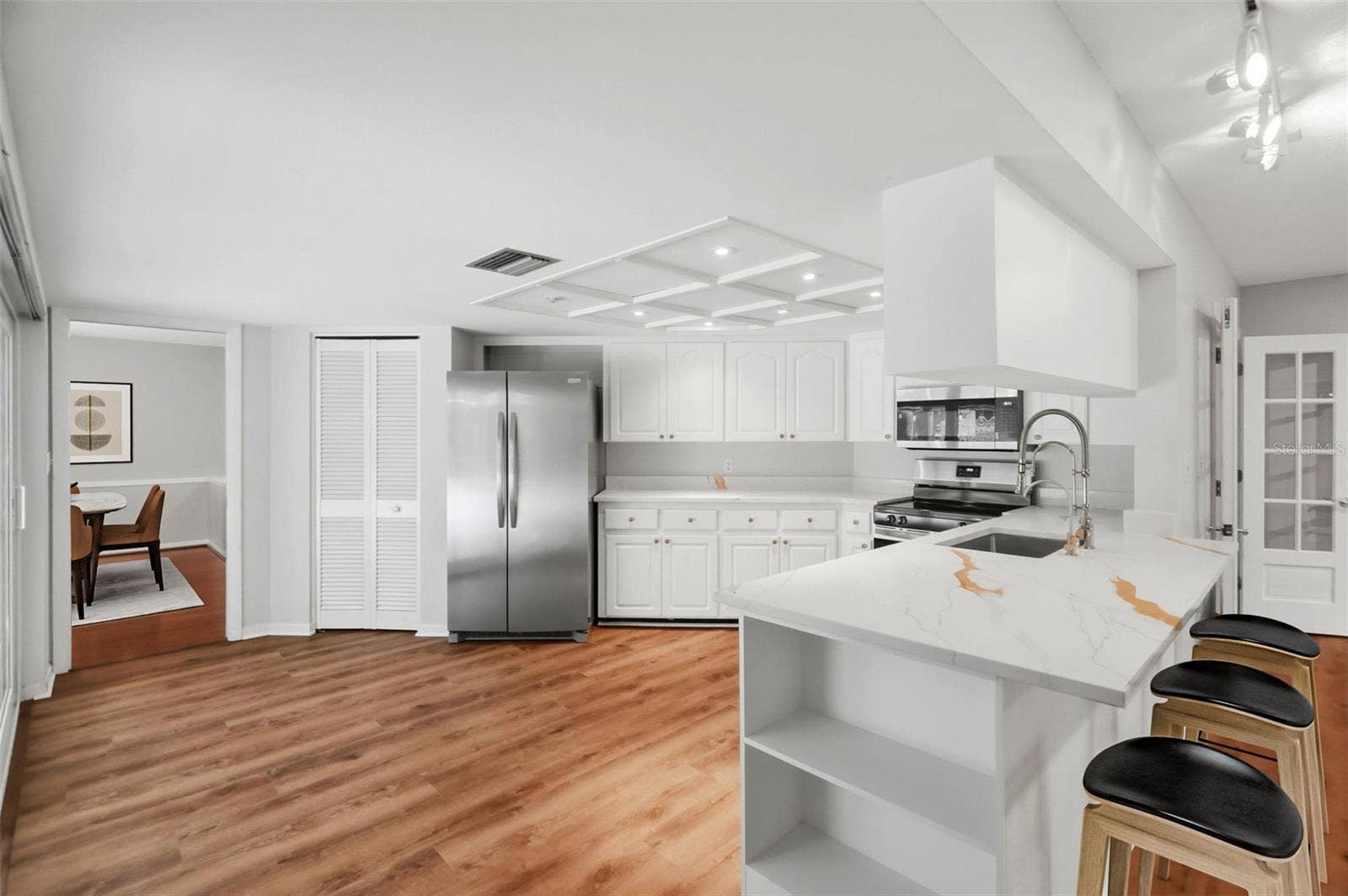 Anchoring the space is a centrally located kitchen.