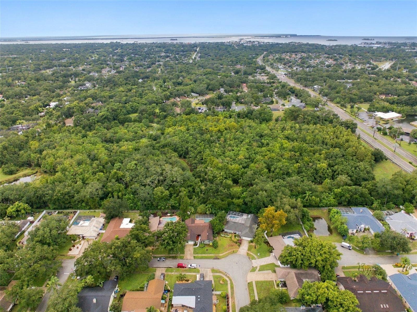 Nestled among the tree-lined streets of Spanish Pines, this residence backs onto Curlew Pond Nature Preserve.